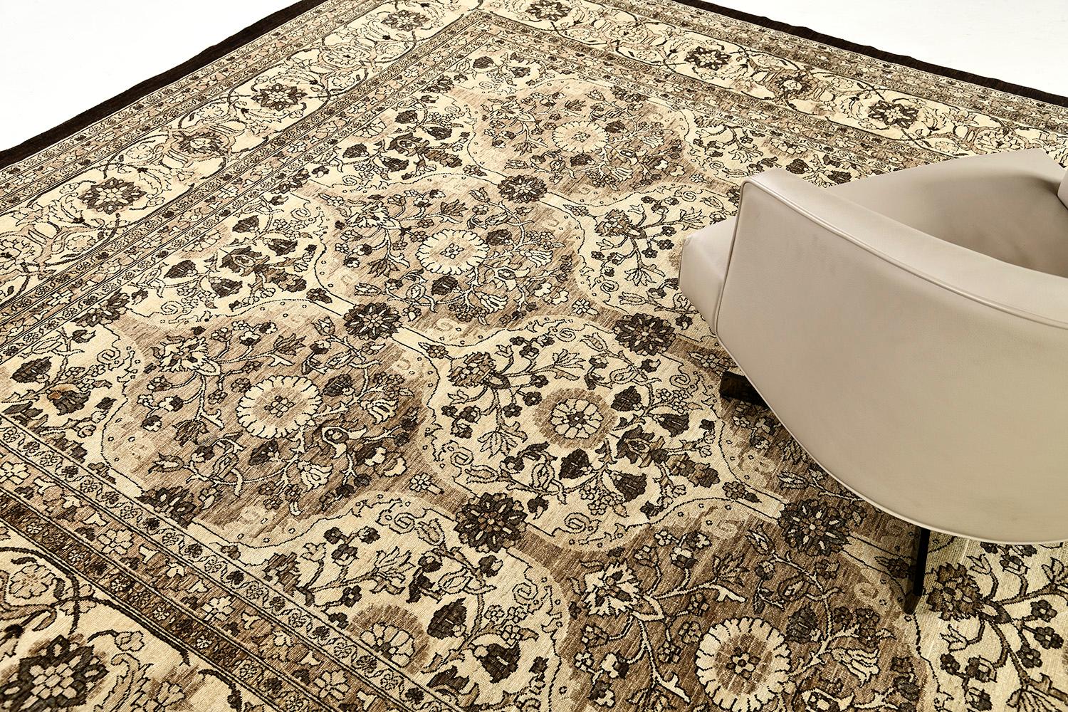 An exquisite Vintage Style Tabriz Revival rug that exudes its classic character through its majestic design and muted warm colour scheme. Featuring the alternating floral motifs that leads to bring a classy, warm and cozy vibe. This rug will