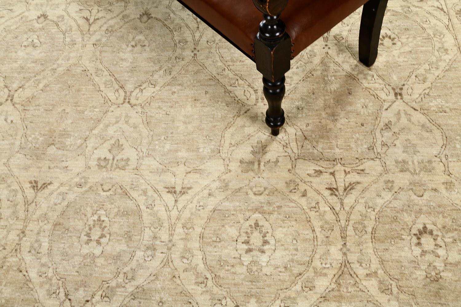 A gorgeous Tabriz revival rug that exudes its natural brilliance. The allover leafy botanical compartmental design highlights its elements within as it unravels throughout this sophisticated rug. Muted and neutral tones of ivory and gray creates an