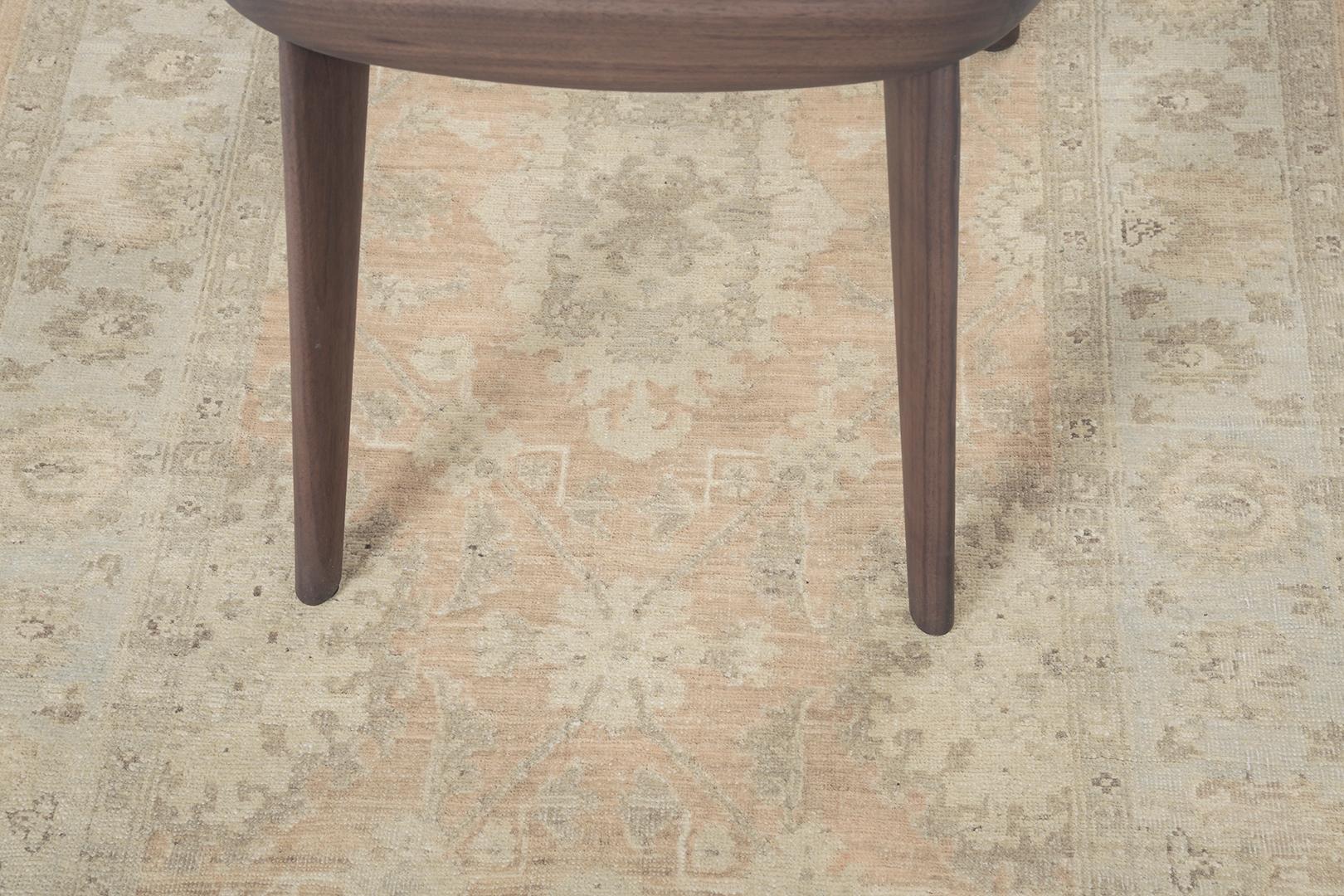 This phenomenal revival of Tabriz runner has an intricate pattern of symmetrical elegant motifs and a controlled ambiance of neutral tones with symmetrical motifs of borders. This masterwork of art utilizes comforting tones to create a warm