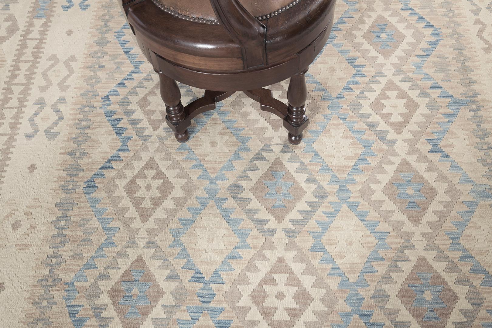 This tribal flat weave in vintage style is adorned with a geometrical tribal design. Naturally dyed Jn neutral tones are a great match for blue hues to enhance this impressive creation. A masterpiece that can be passed on in the next coming