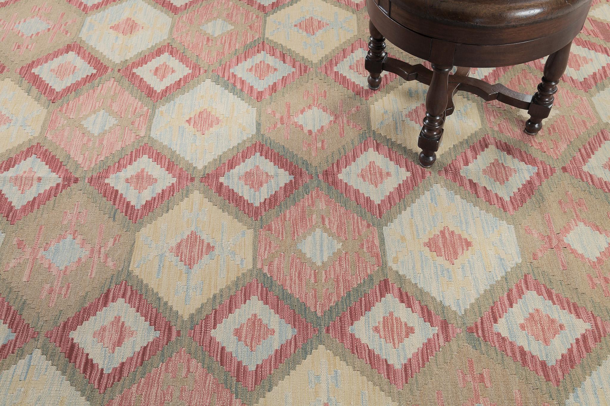 A stunning vintage-styled flatweave Kilim features geometrical motifs through a warm-toned palette. The geometrical patterns create a joyous and charming design for an immense variety of interiors. This such kinds of rugs bring your room more
