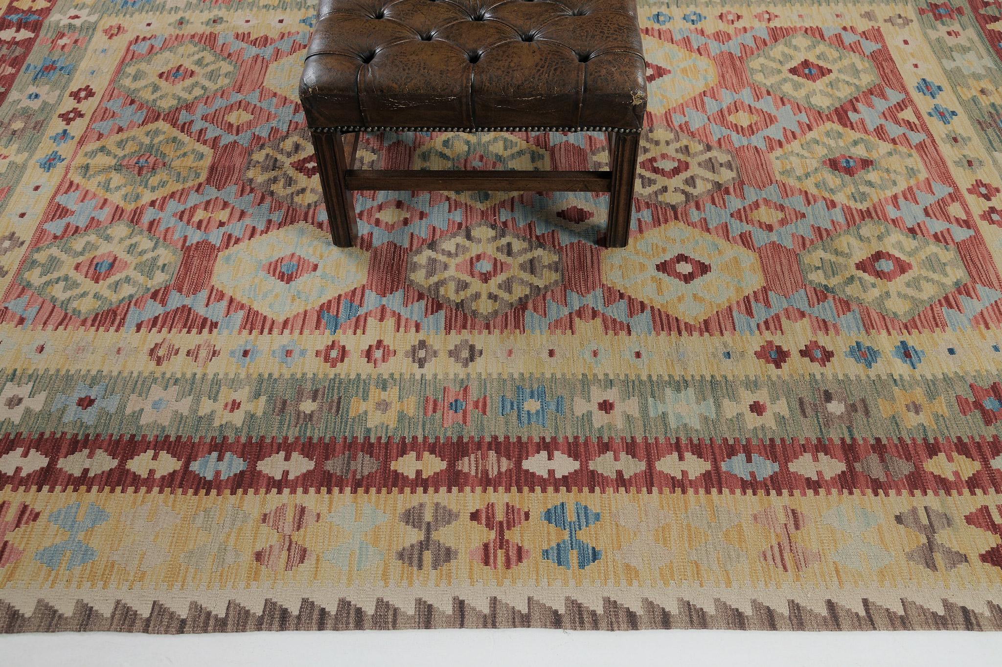 Tribal symbolic motifs are featured and the center of the charm. Series of geometrical bands along the fringe of this impressive flat weave Kilim. Using vibrant palettes makes it more wonderful and enticing for conventional and modern-inspired