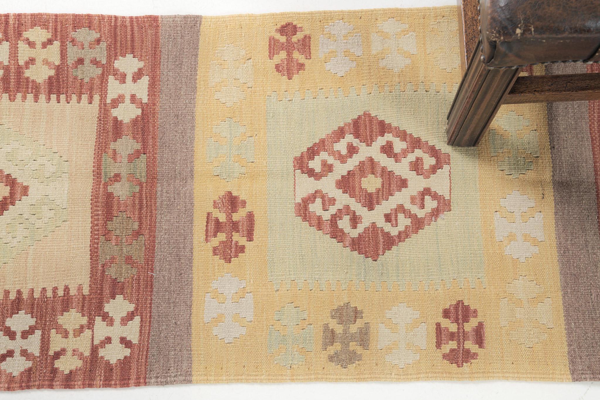 This flatweave Kilim features the loveliest shades of yellow as its prominent color palette. Adding to its stunning aesthetic are khaki and reds that pop and make this rug stand out. The center of the rug features eyes, water, diamonds, and tribal