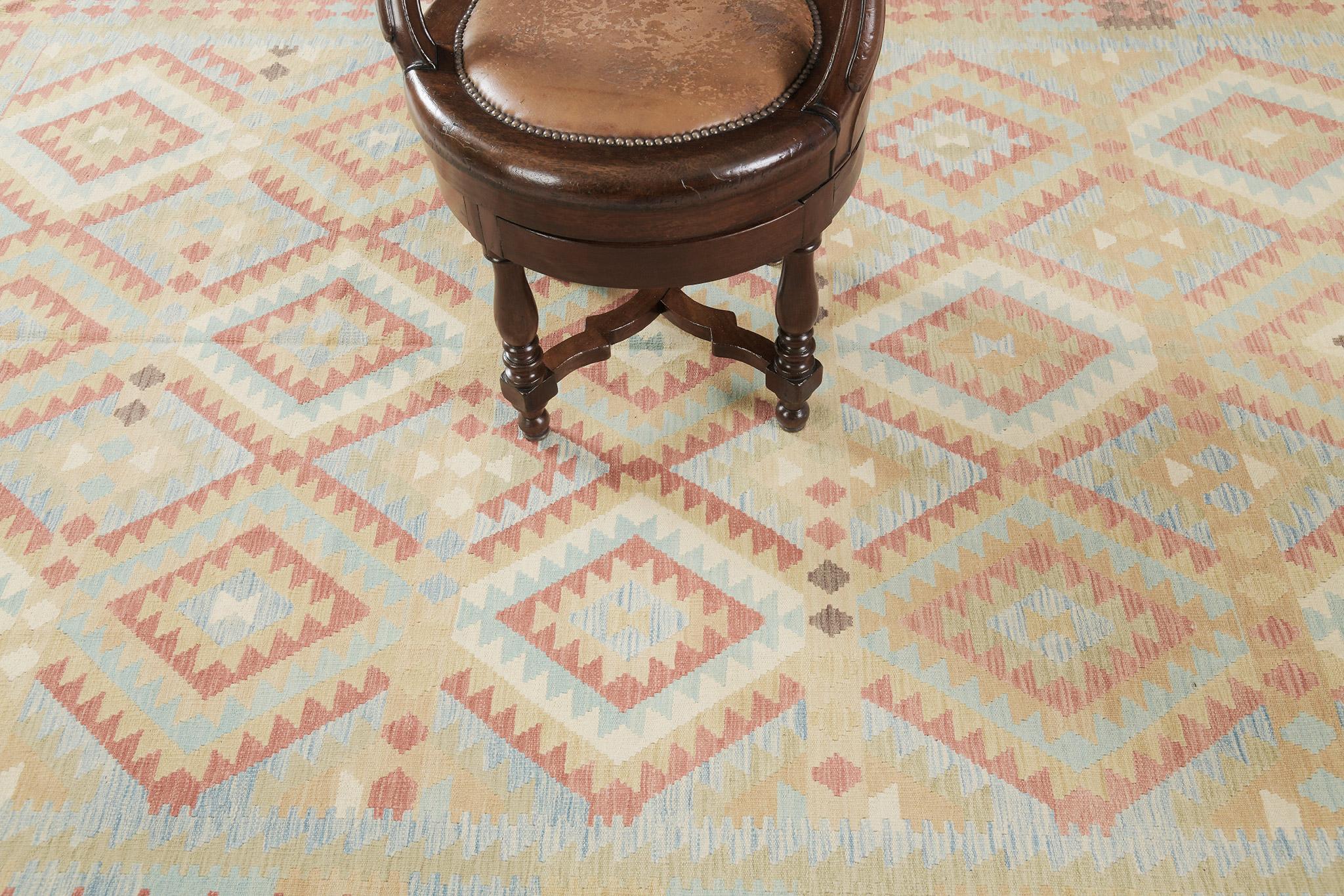 The geometrical patterns create a positive and pleasant design for an enormous variety of interiors. This remarkable vintage-styled flatweave Kilim features geometrical motifs and symbols through a warm-toned palette. A masterpiece that will