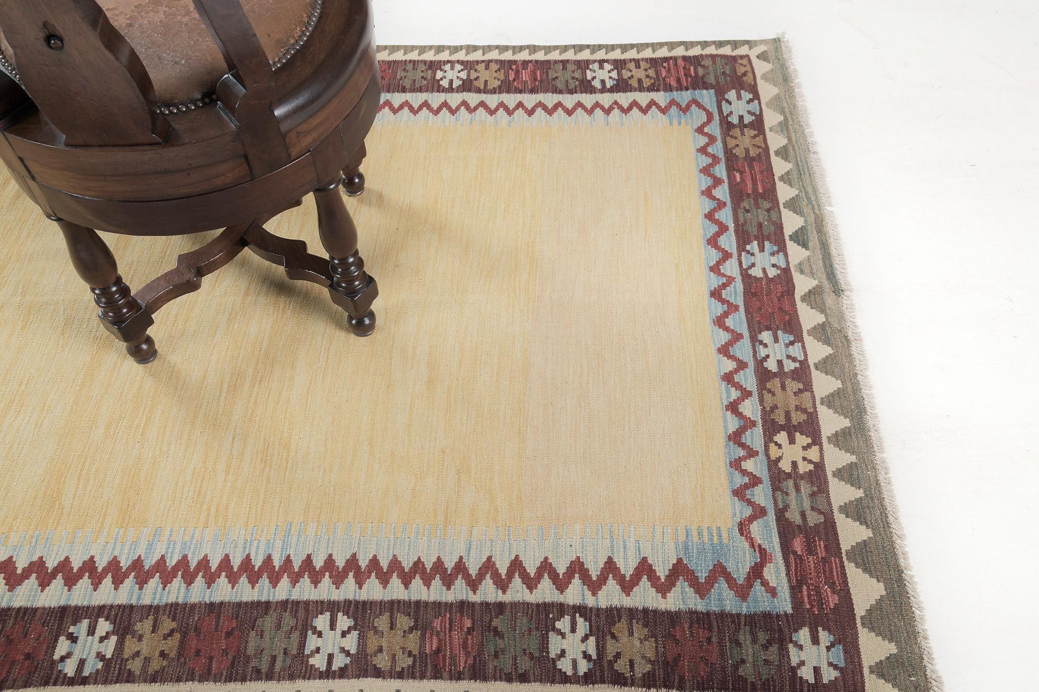 A joyous tribal flatweave features a radiant yellow field surrounded by multicolored motifs and red zigzags. This remarkable tribal rug from our collection is a must-have on your list. The perfect centerpiece that will be adored by many.

Rug