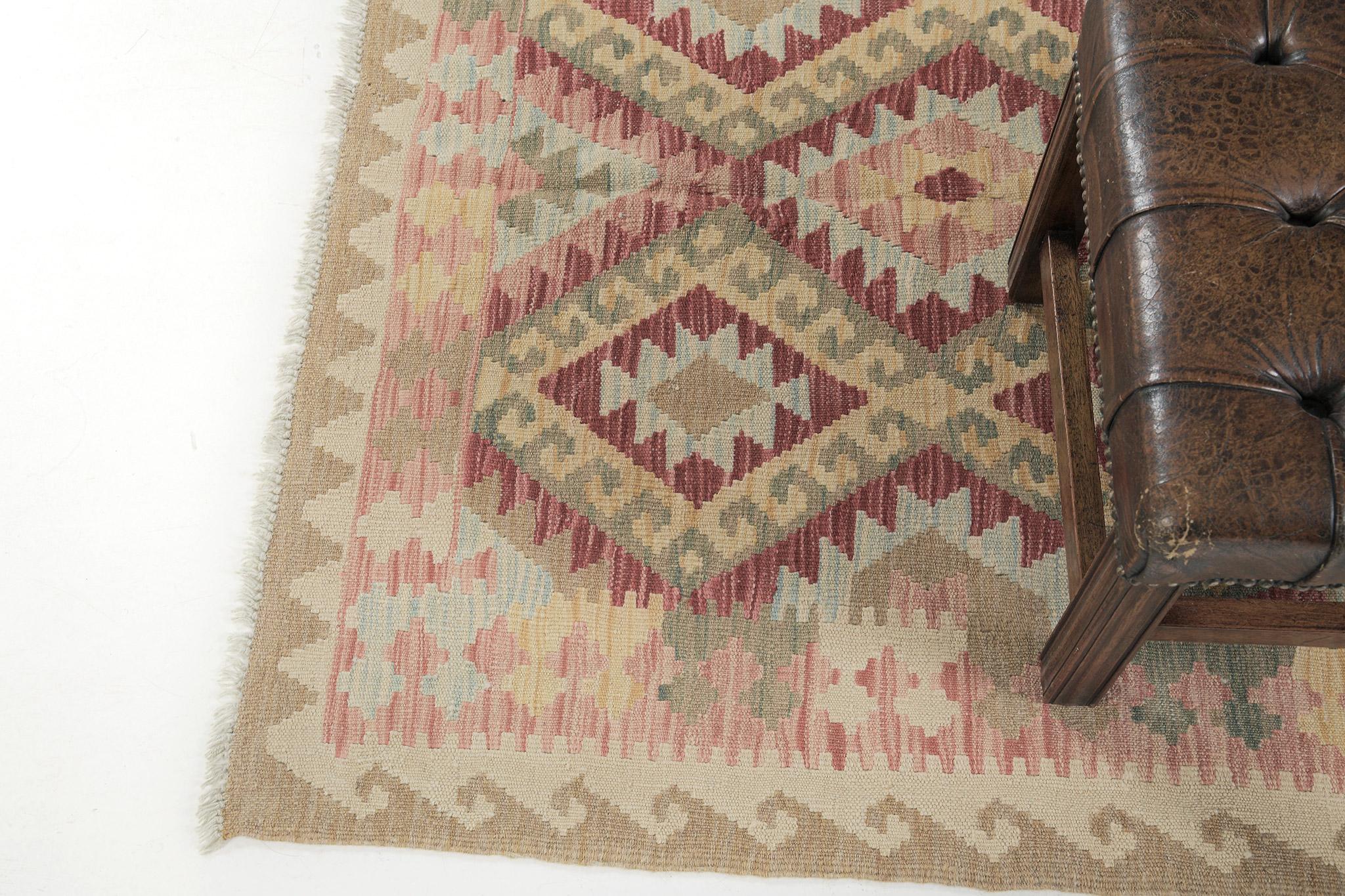A gorgeous vintage-styled flatweave Kilim is banded with a zigzag pattern. The patterns are also in diamond style with triangular motifs that create a festive and interesting design for a large variety of interiors. A masterpiece that will set your