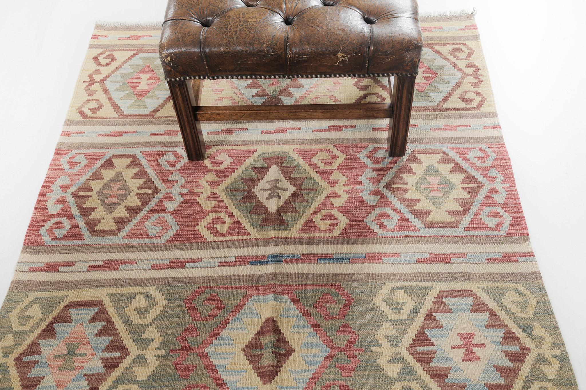 Modernize your little sanctuary with our vintage-styled Kilim which is made out of wool. All the diamond patterns and motifs blend to construct a stunning panel pattern. Its earthy tone palette added to the uniqueness and elegance of this