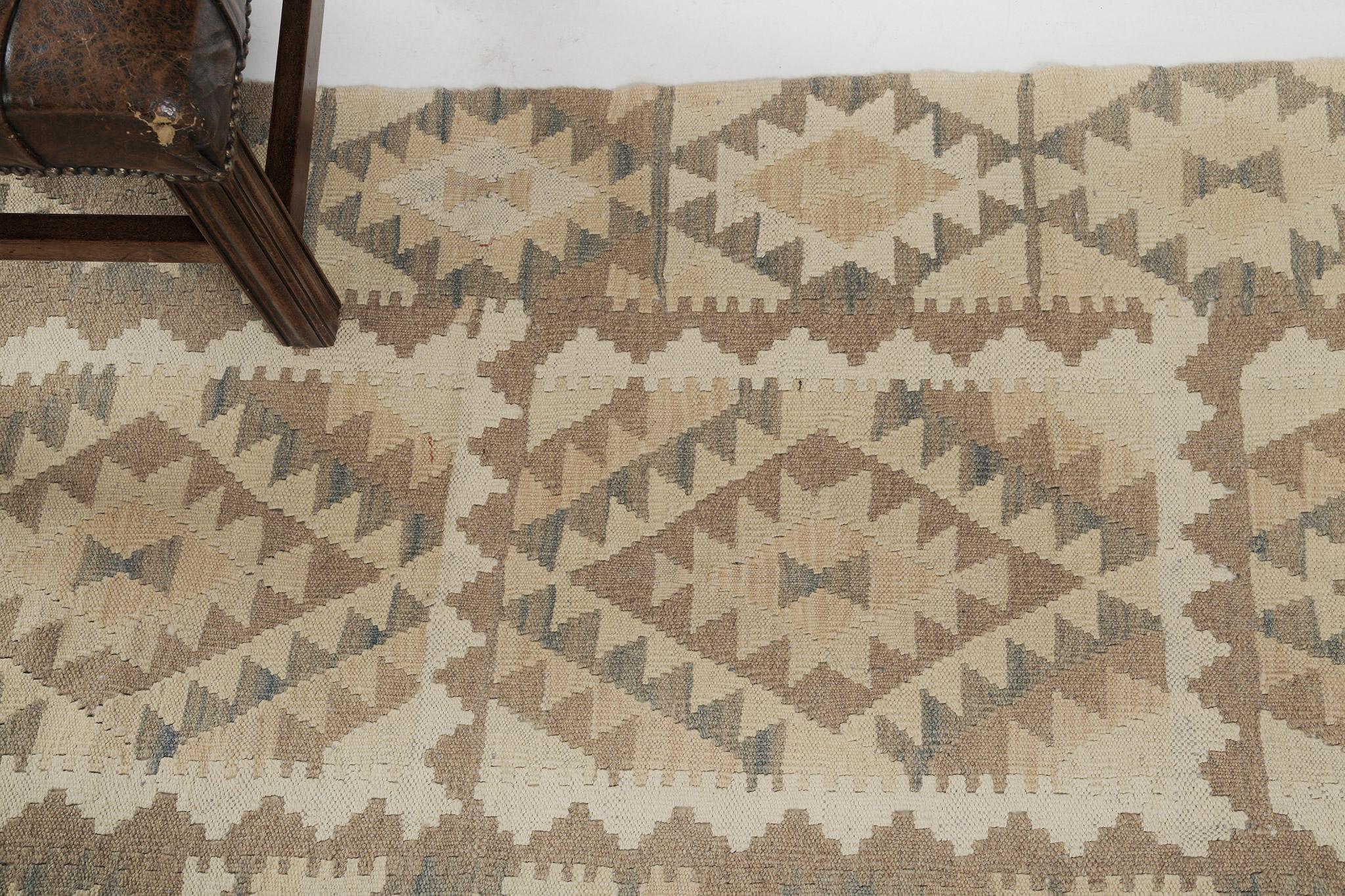These tribal patterns create a promising and remarkable design for traditional interiors. This incredible vintage-styled flatweave Kilim features geometrical tribal motifs and symbols through panel design of multi-colored natural palettes. A