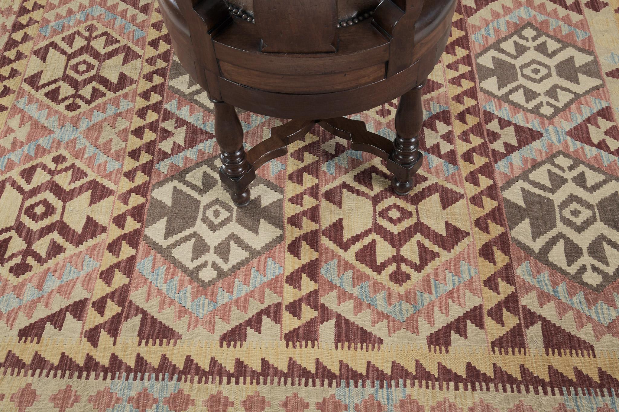 Our natural dyed flatweave Kilim in vintage style rug is inspired by tribal patterns. This kilim is a deal for flooring or wall applications. It is adorned with crab motifs in multicolored schemes and surrounded by zigzag patterns that make this rug