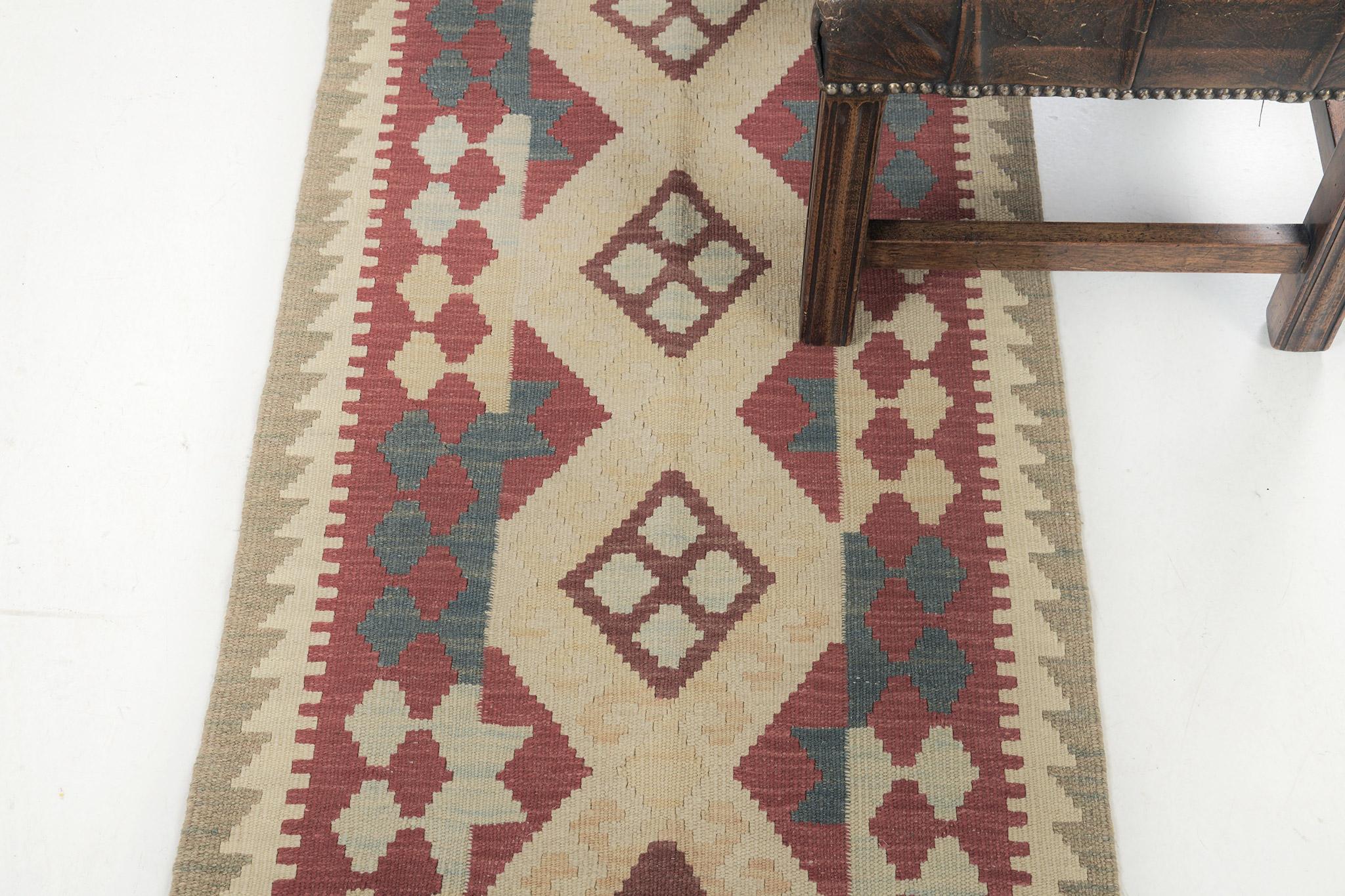 A gorgeous vintage-style Kilim flatweave banded with a neutral palette zigzag. The series of diamonds create a simple yet interesting design for a wide variety of interiors in a brilliant red field. Interestingly enough for your home interiors and