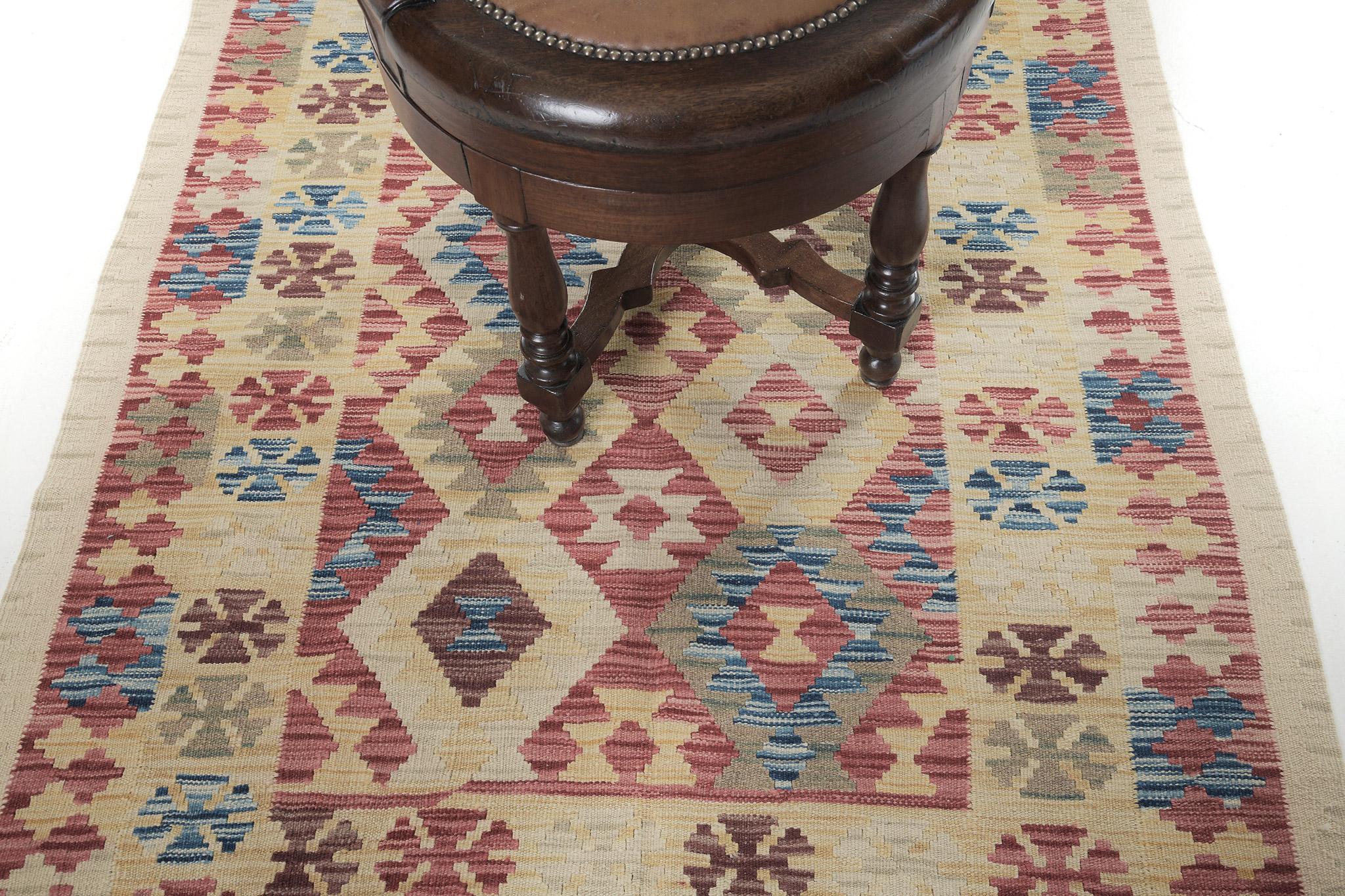 Vintage-styled flatweaves are made up of some of the promising wool and weaved incredibly to create charming textures. This naturally dyed Kilim is a banded flat weave with alternating enthusiastic colors in red, maroon, blue, and yellow. This piece