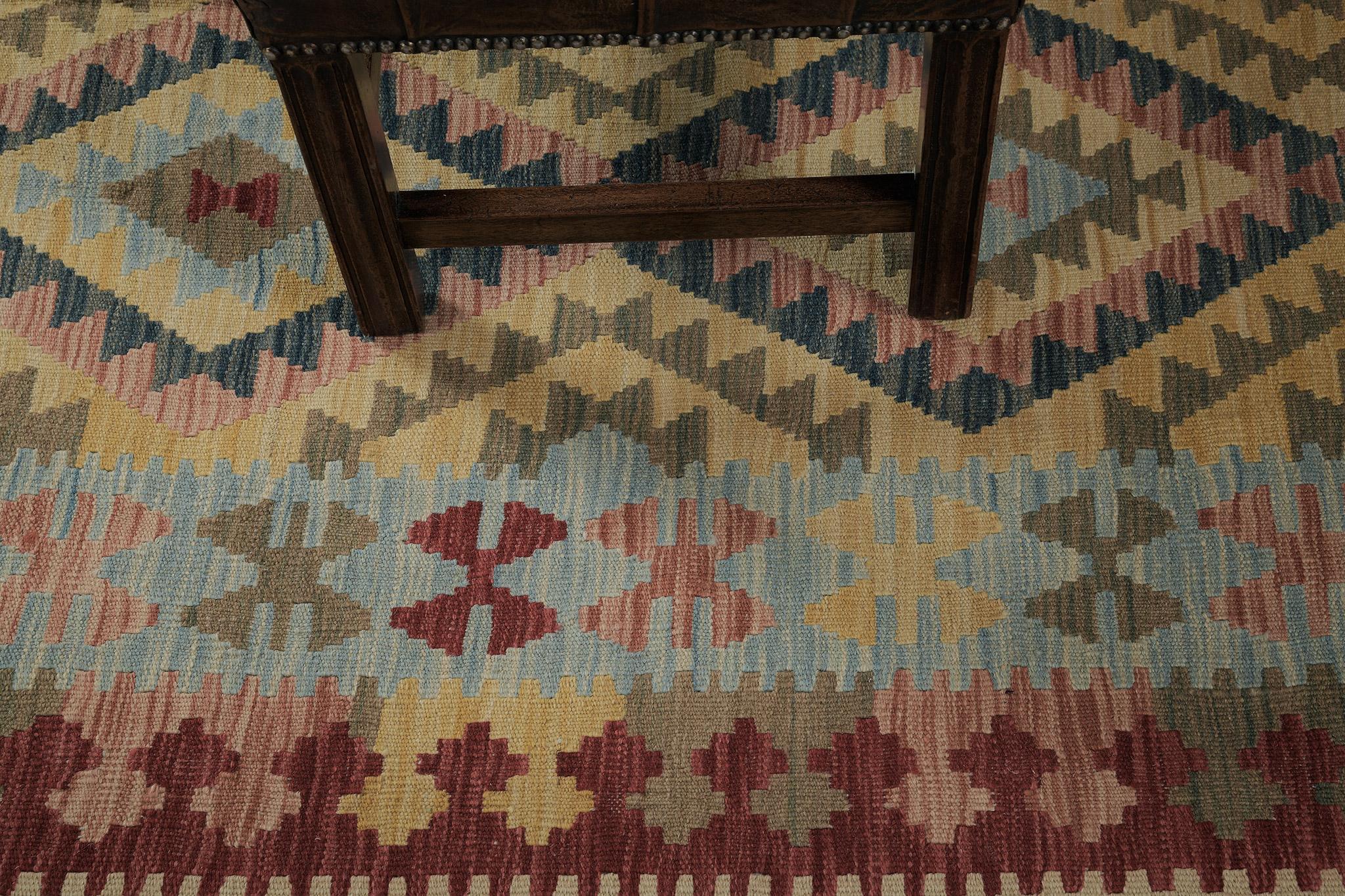 This multicolored flatweave kilim features an allover design of the diamond motif, triangles, and other tribal motifs. Having this kind of motif it makes more meaningful because of the beautiful details surrounding it. Traditional interiors are the