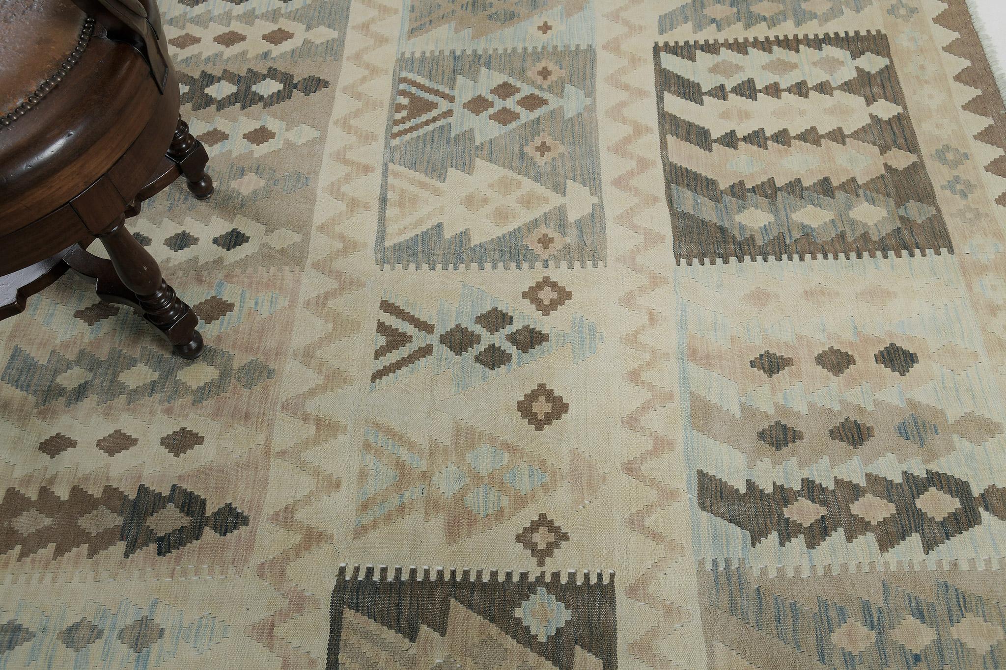 A luxurious vintage-style Tribal flat weave is banded with brown geometric elements. The earth-hued impressive designs create a natural yet fascinating design for an extensive variety of interiors. Its technique and creativity leave a powerful