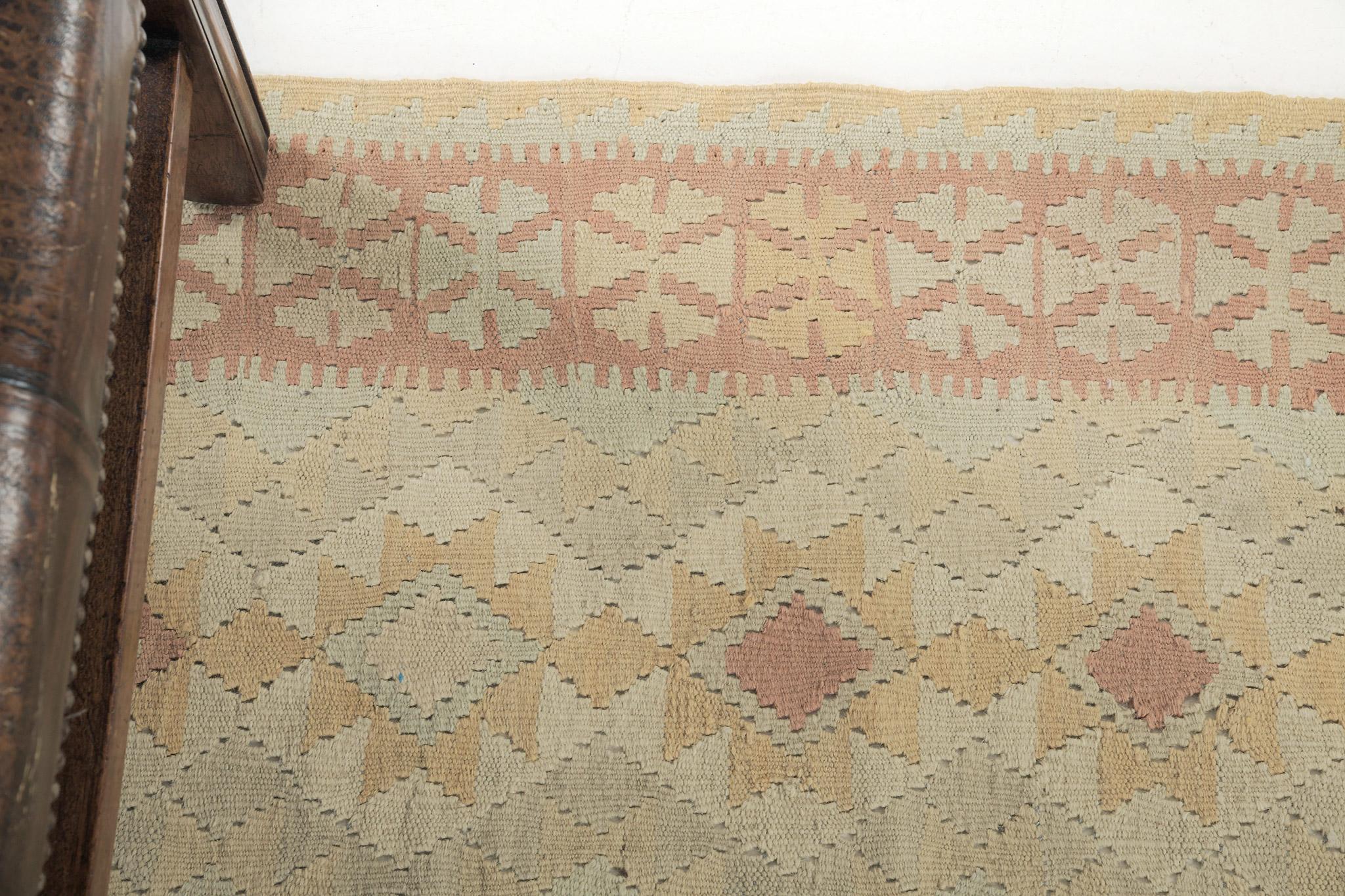 Adorn your space with festive vibes with our flatweave Kilim. It highlights the diamond patterns and is surrounded by tribal symbols on its core. These strong details will brighten up the mood of every guest. Trendy for every designed space that