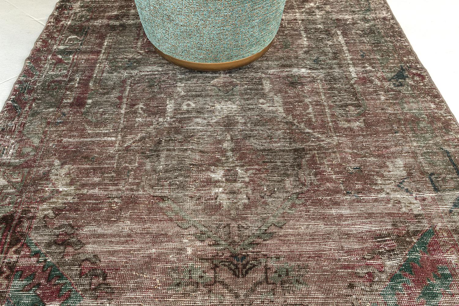 A Vintage Turkish Anatolian rug that is poised to impress. Characterized by its ornate botanical details and vibrant colour scheme, this elaborate design creates a mesmerizing sense of well-balanced proportions. Taking center stage is a central