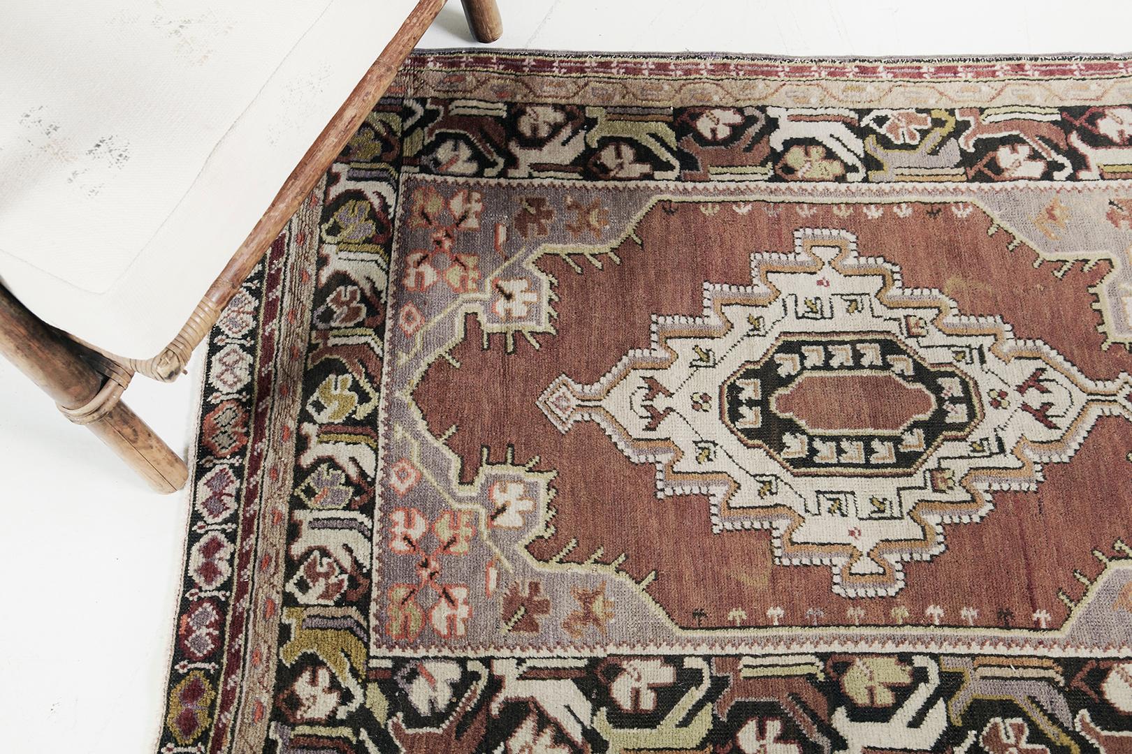 Majestic elegance and vivid colors bring alluring appeal to this Vintage Turkish Anatolian rug. It embodies the captivating Anatolian style with an all-over ornate pattern composed of palmettes and stylized florals dancing along the graceful motifs
