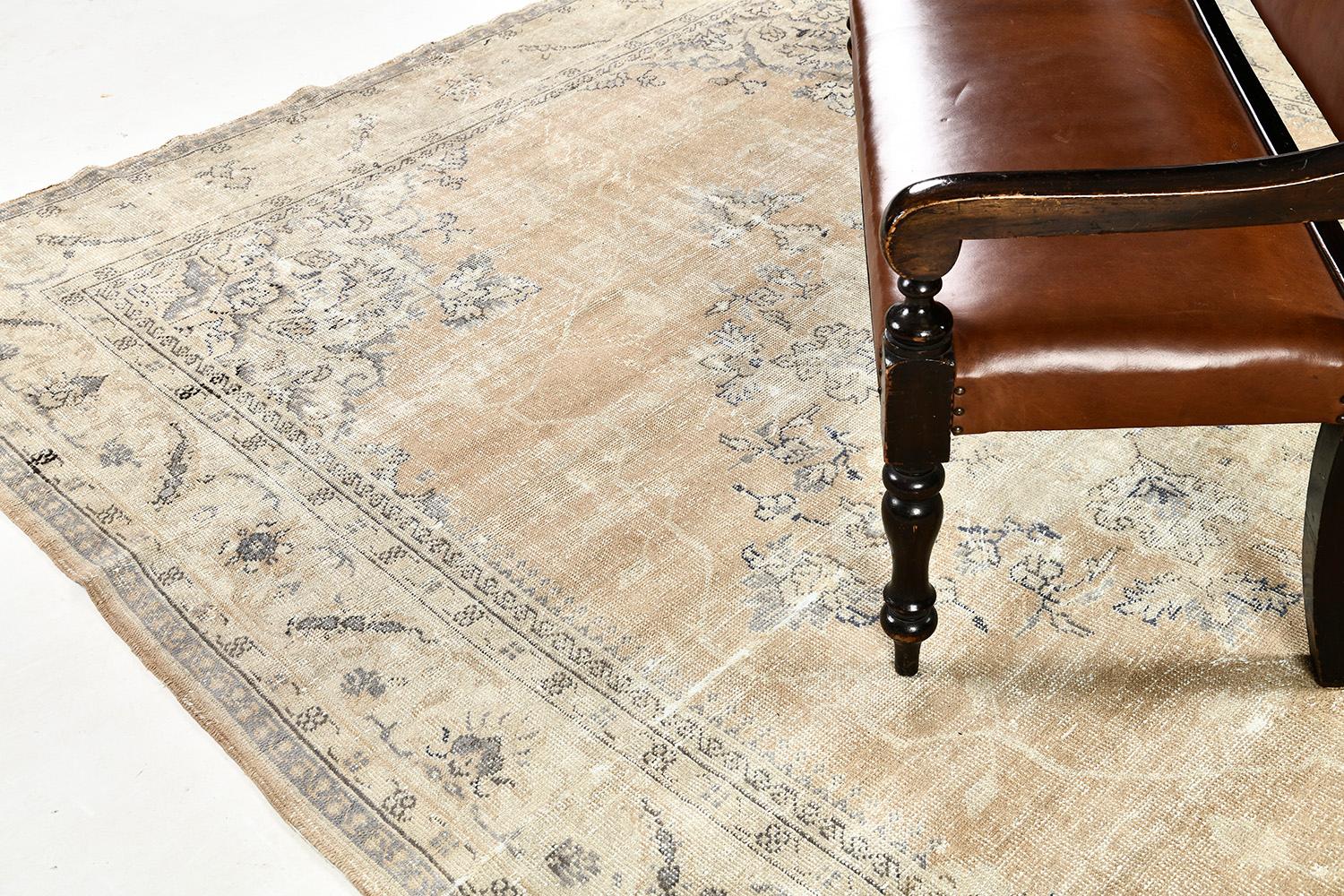 A timeless and luxurious vintage Turkish Anatolian rug has a soft tan field that brings life and light to your spaces. This rug is cultivated with symmetrical patterns of delicate vines and outlines through beautiful wool. Anatolian was made to be