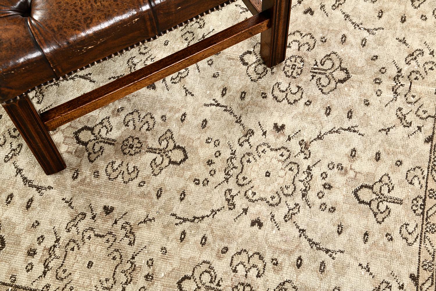 A timeless and luxurious vintage Anatolian rug has its soft tan field that brings life and light to your spaces. This rug is cultivated with symmetrical patterns of delicate vines and outlines through beautiful wool. Anatolian was made to be lived