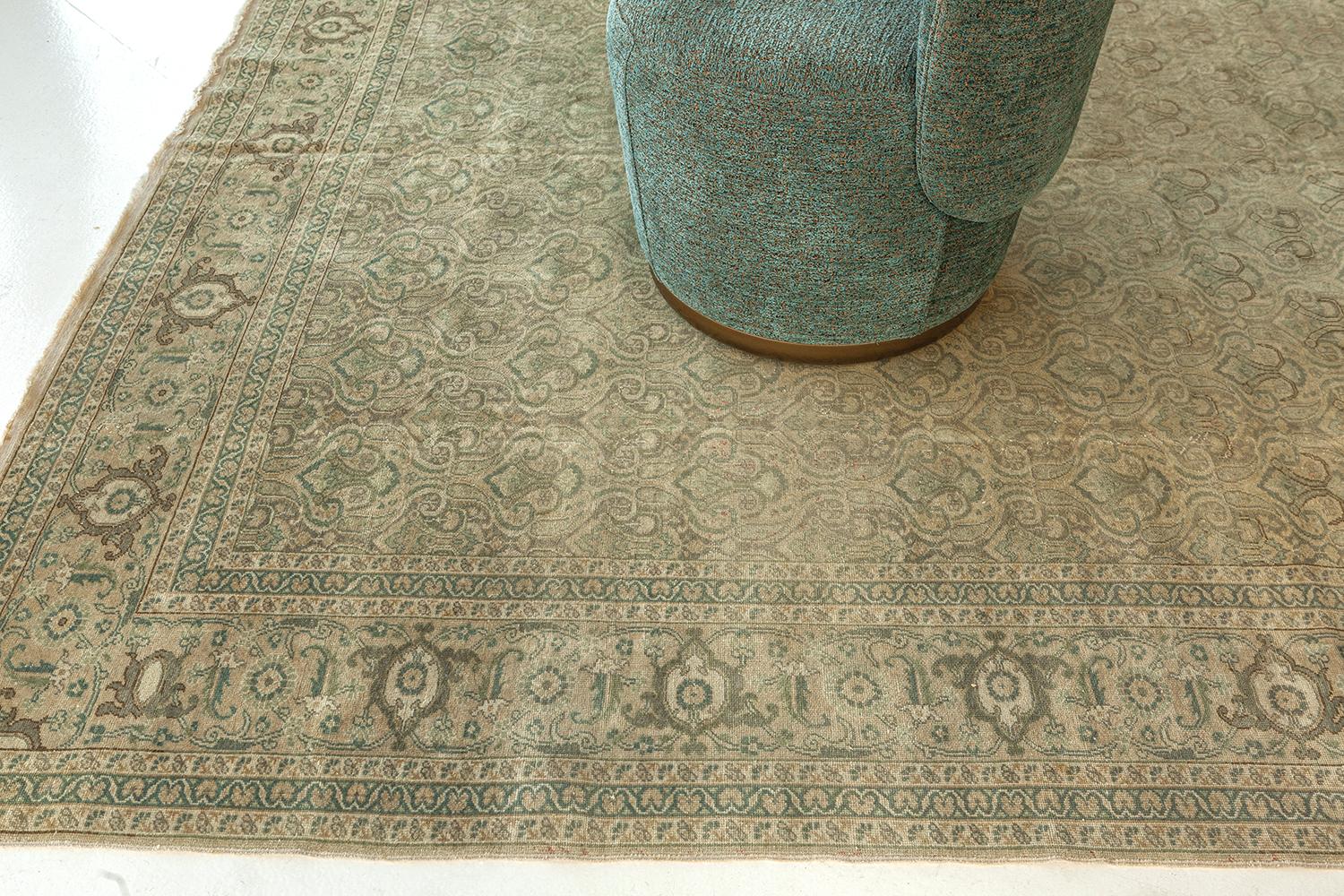 Showcasing timeless elegance in a muted color palette, this Vintage Turkish Anatolian rug features an all-over pattern of stylized florals in shades of beige, ecru, and hazelnut. Natural abrash gradations substantiate this gorgeous vintage rug and