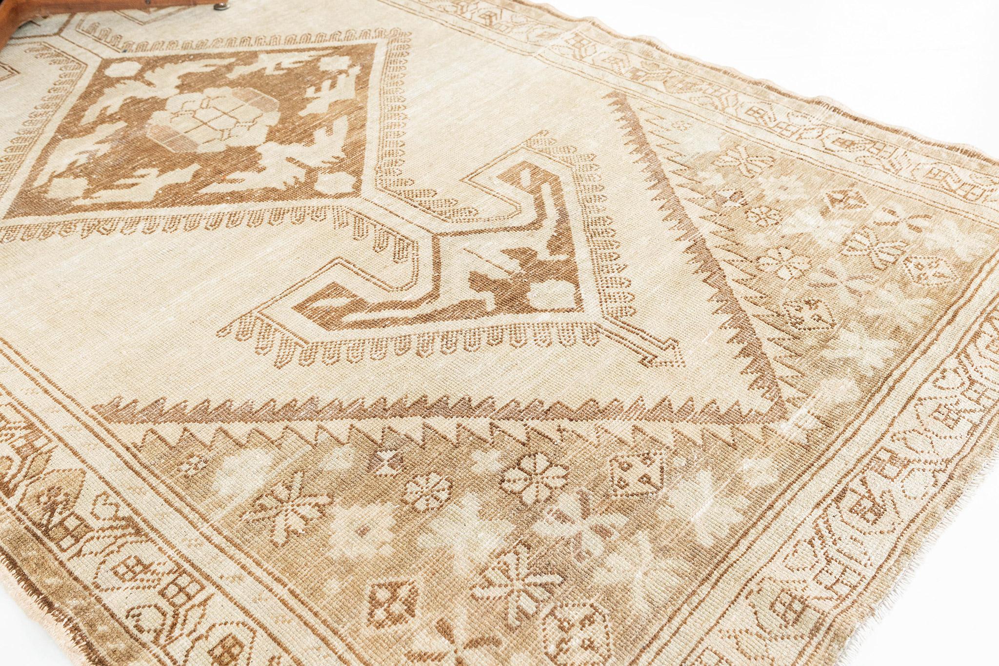 A Vintage Turkish Anatolian rug that is poised to impress. Characterized by predominantly tribal style with its ornate botanical details and muted colour scheme, this elaborate design creates a mesmerizing sense of well-balanced proportions. Taking
