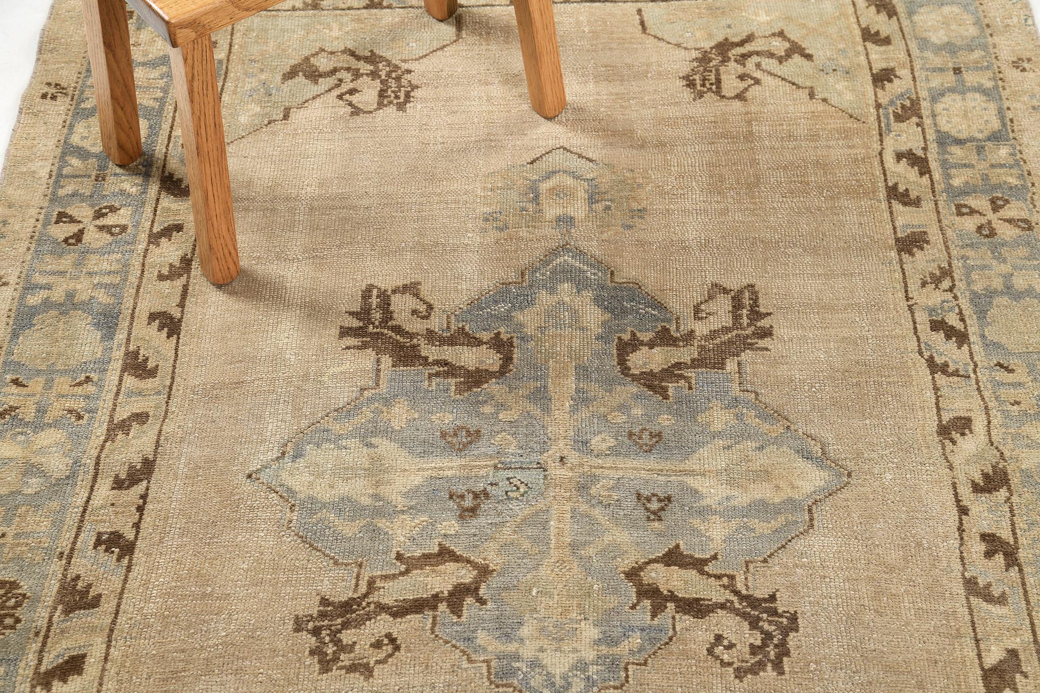 A Vintage Turkish Anatolian rug that is poised to impress. Characterized by predominantly majestic style with its ornate botanical details and fascinating colour scheme of beige and sage green, this elaborate design creates a mesmerizing sense of
