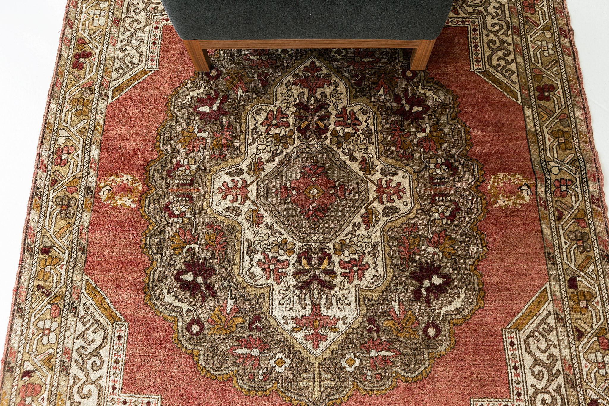 A Vintage Turkish Anatolian rug that is poised to impress. Characterized by predominantly Anatolian motifs with its ornate botanical details and warm colour scheme, this elaborate design creates a mesmerizing sense of well-balanced proportions.
