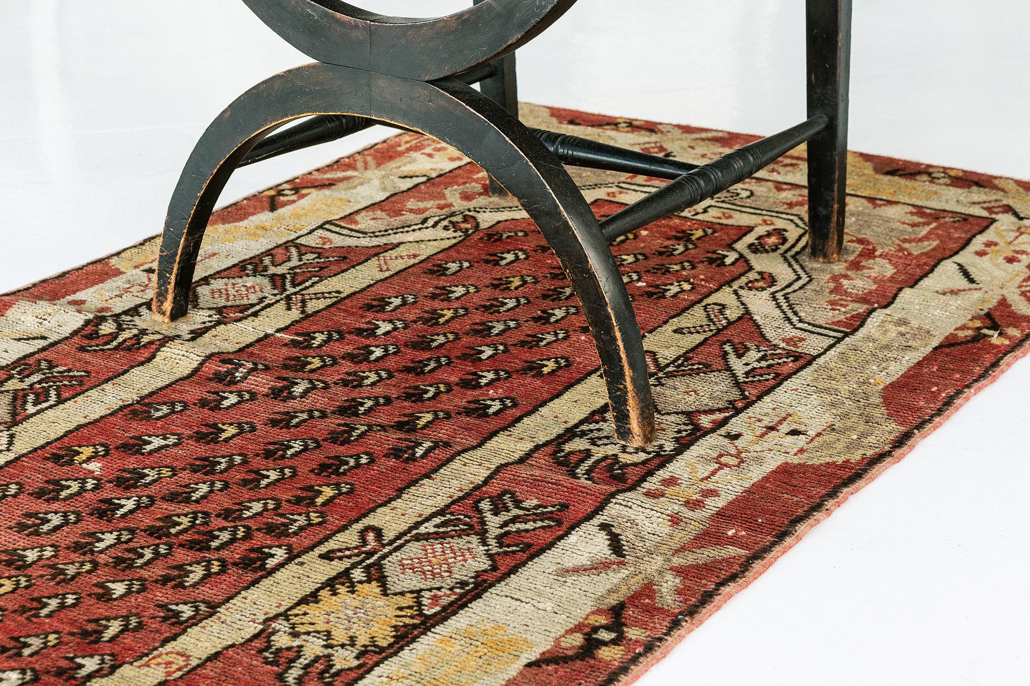 Impressive in style and scale, this Vintage Turkish Anatolian rug features an overall luxurious composition depicting age-old Anatolian motifs. In the Classic Turkish style, the highly decorative all-over botanical details are displayed in an