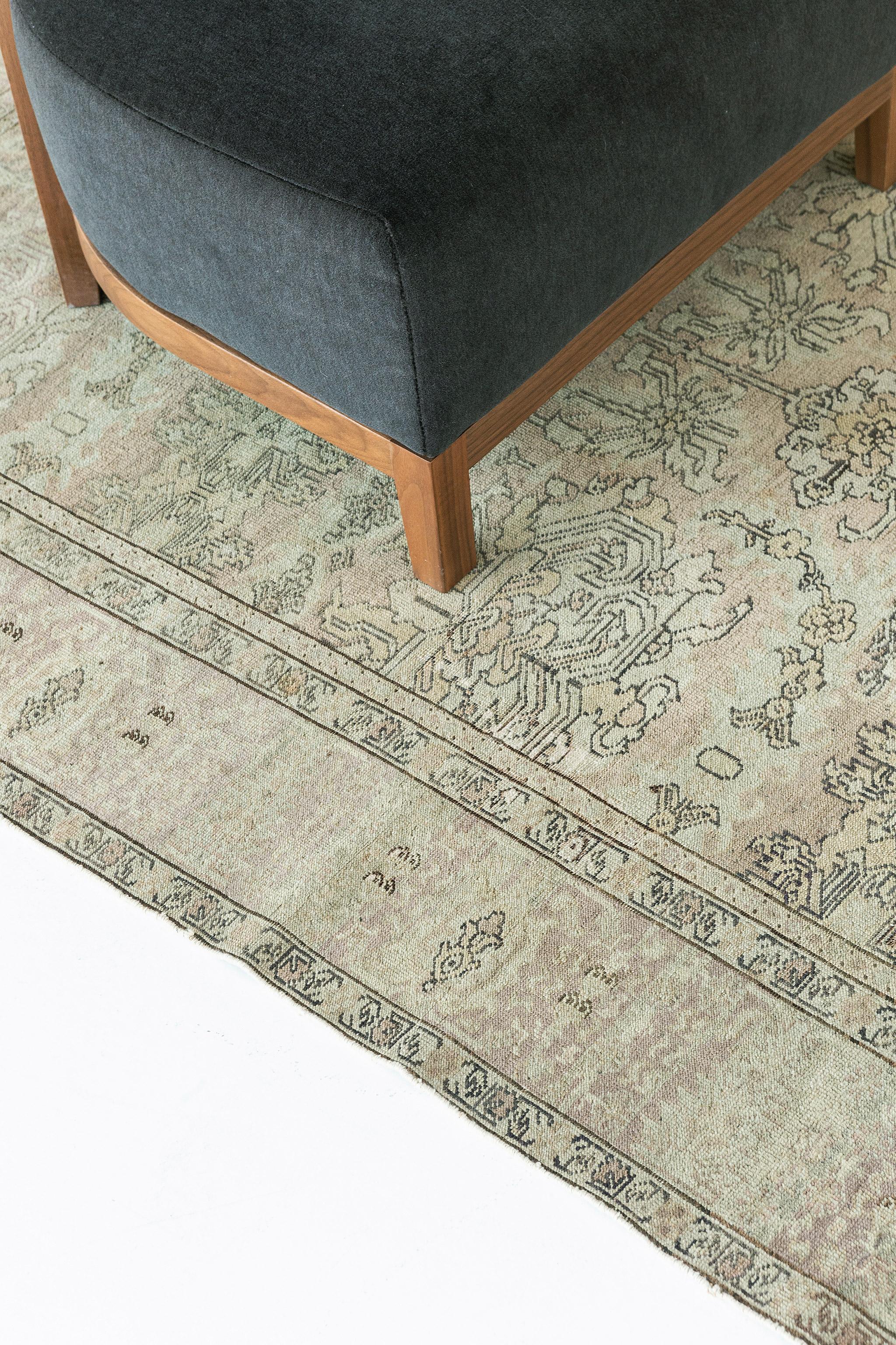 A stylish Oushak revival rug in the muted tones of terracotta and sandy beige stylized gracefully with majestic botanical details. Classic, calm and cozy, this rug from hand spun wool is framed by a complementary border filled with elements that