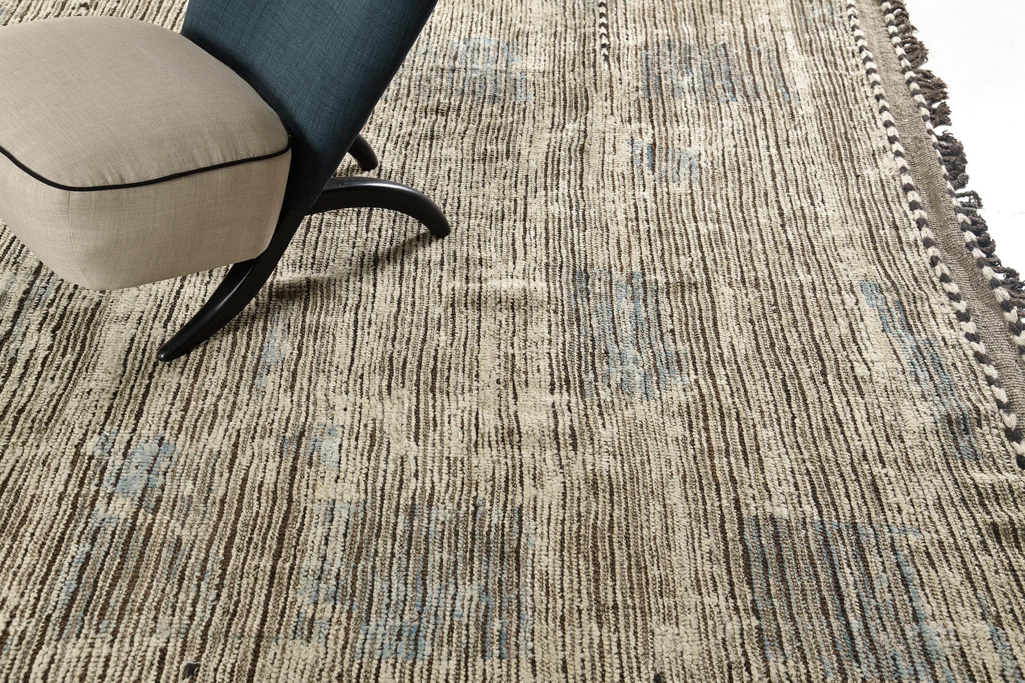 Zeki' est un tissu à poils tissés à la main de couleur ivoire naturelle avec des détails en relief dans un shag beige et beige. Les accents bleus céruléens soulignent gracieusement le caractère de ce tapis impressionnant qui apporte un sentiment