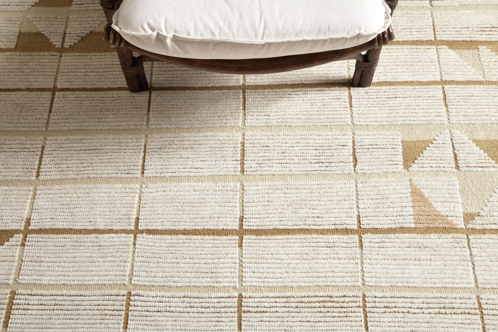 Bouchet’ in Estancia Collection features rectangular grids running along the entirety of this breathtaking rug. Rendered in the earthy shades of beige and tortilla, features the puzzle like forming lozenges which creates statement and character in