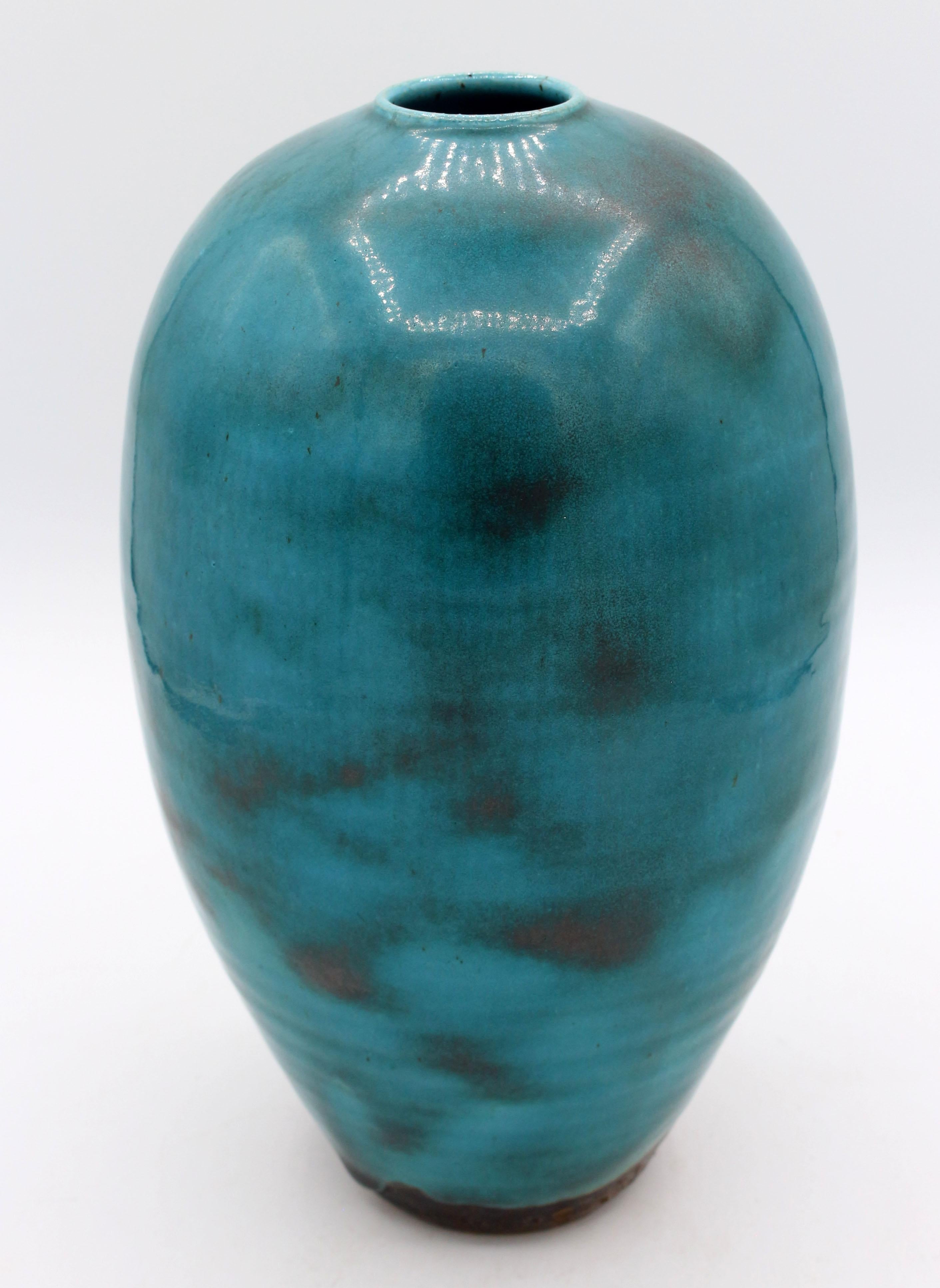 1997 Mei Ping Oriental Translation blue glazed vase by Ben Owen III. Rippling copper through the glaze.
9