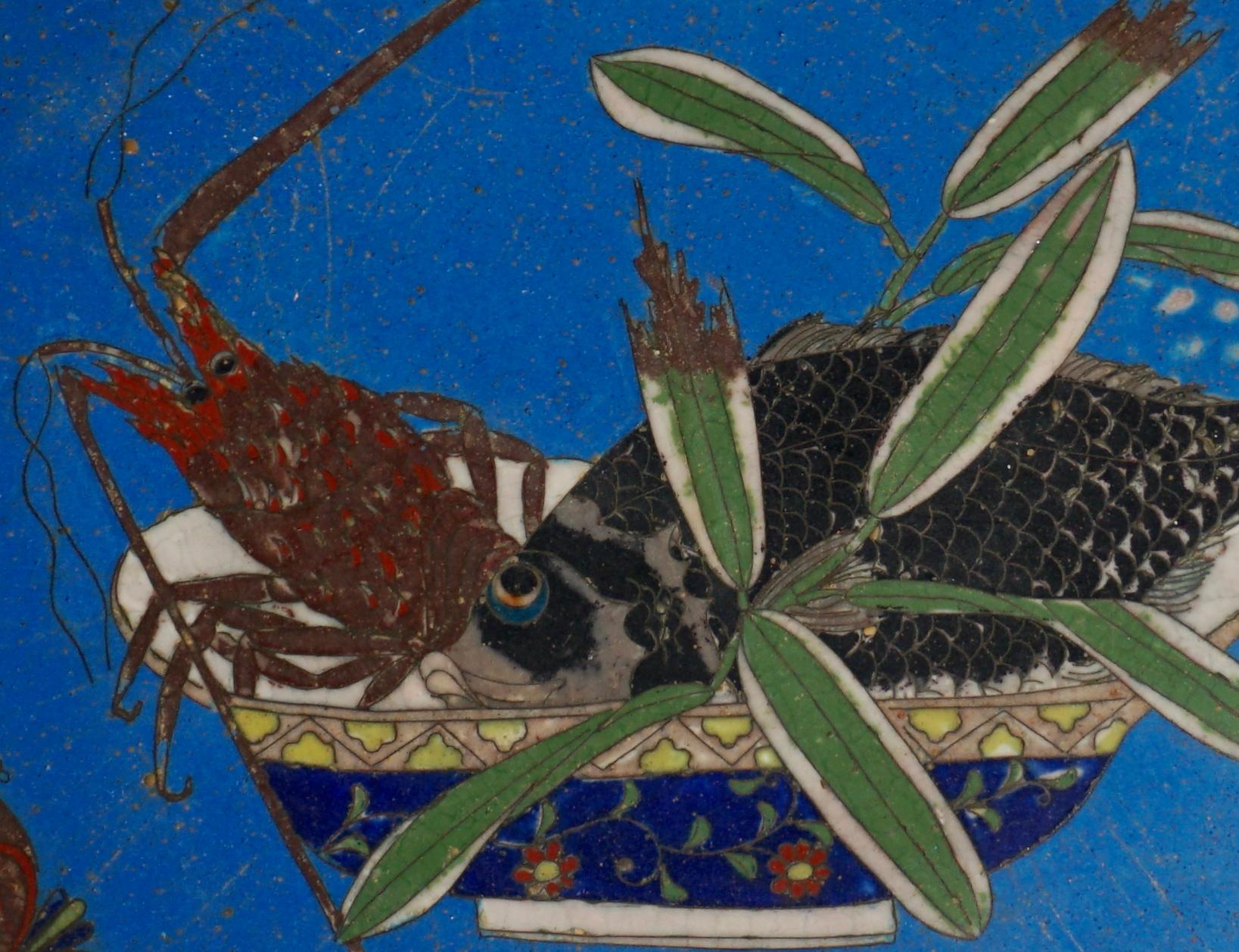 A early and exquisite Japanese Cloisonne platter in rare lapis lazuli cobalt blue background with a seafood bowl filled with a carp fish and a lobster. The lobster and fish have eye balls looking at a dragonfly that is sitting on the lobsters