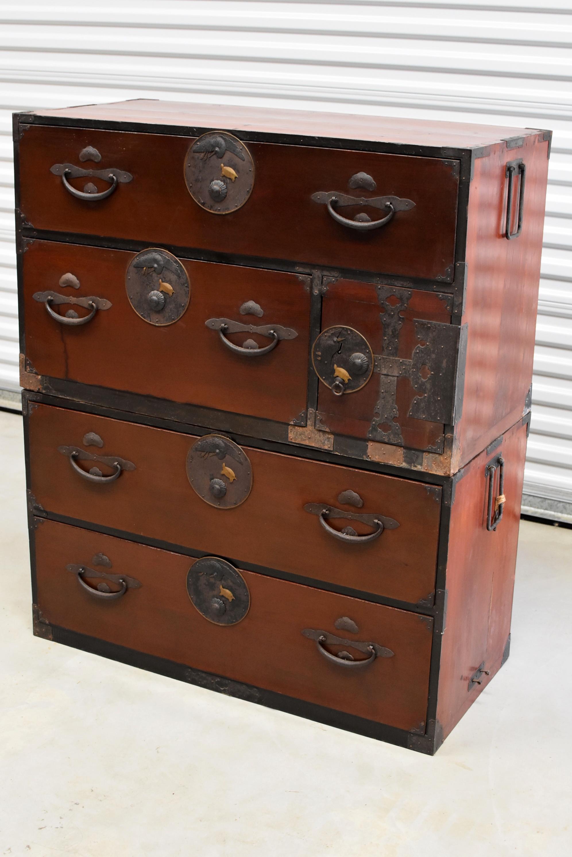 A beautiful vintage Japanese Tansu consists two individual chests that can be used separately. Beautiful, very unique, solid brass and iron hardware features cranes and turtles, both are symbols of long life and eternity. Chestnut chocolate finish