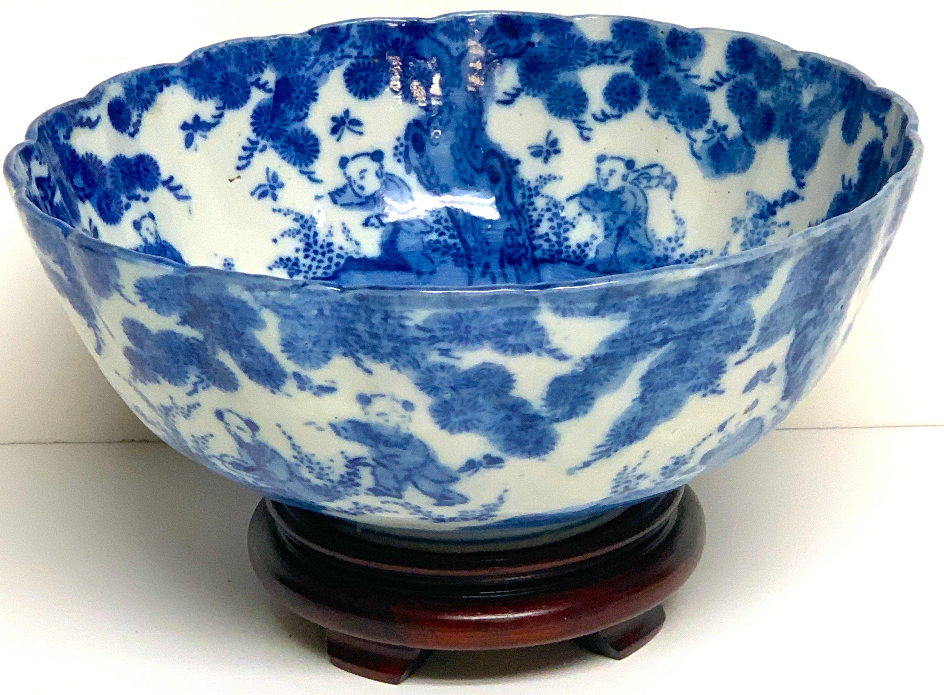Meiji Period blue and white Imari scalloped bowl with stand. Decorated inside and out with typical landscape scenes, includes 4