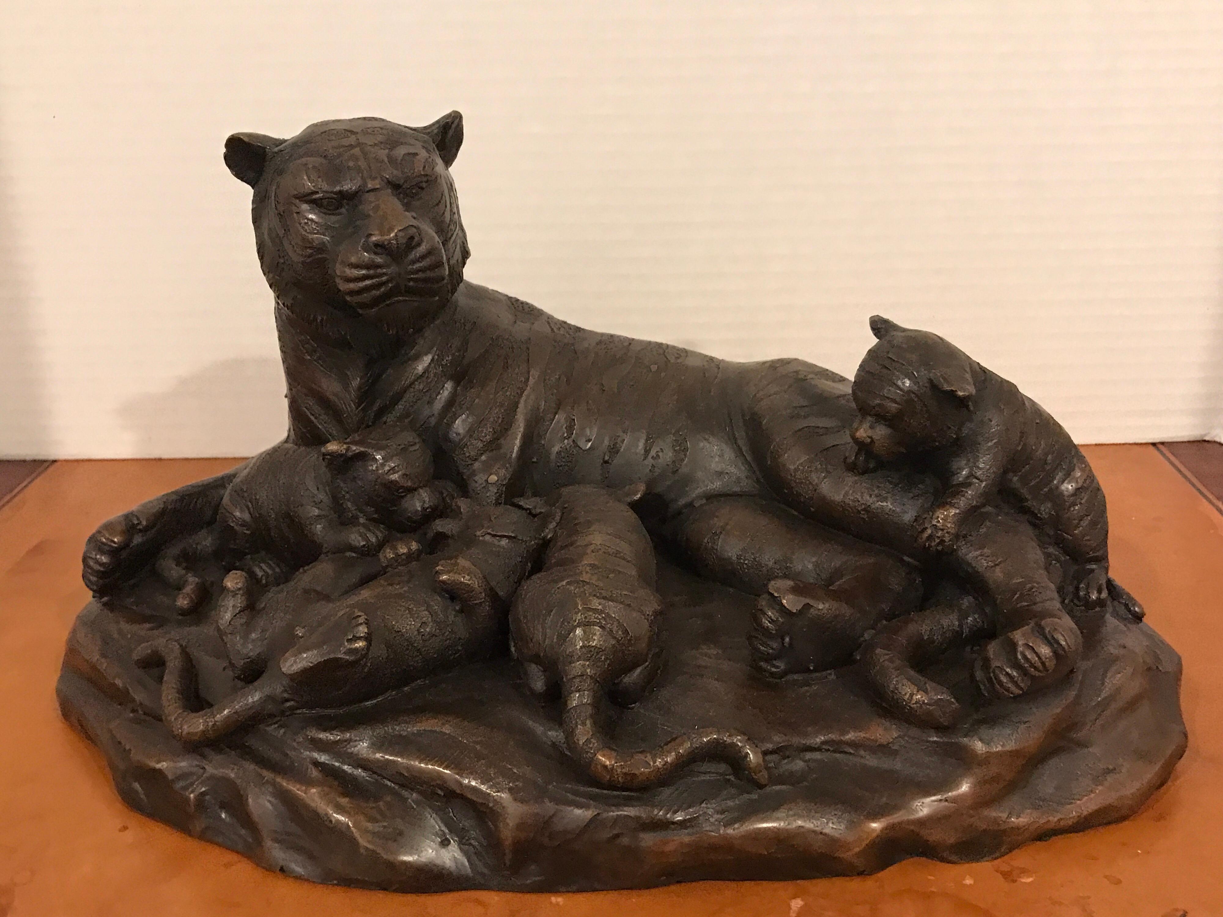 Meiji period bronze grouping of tigers, depicting tigress and cubs bronze, realistically cast and modeled, with four frolicking cubs, unmarked.