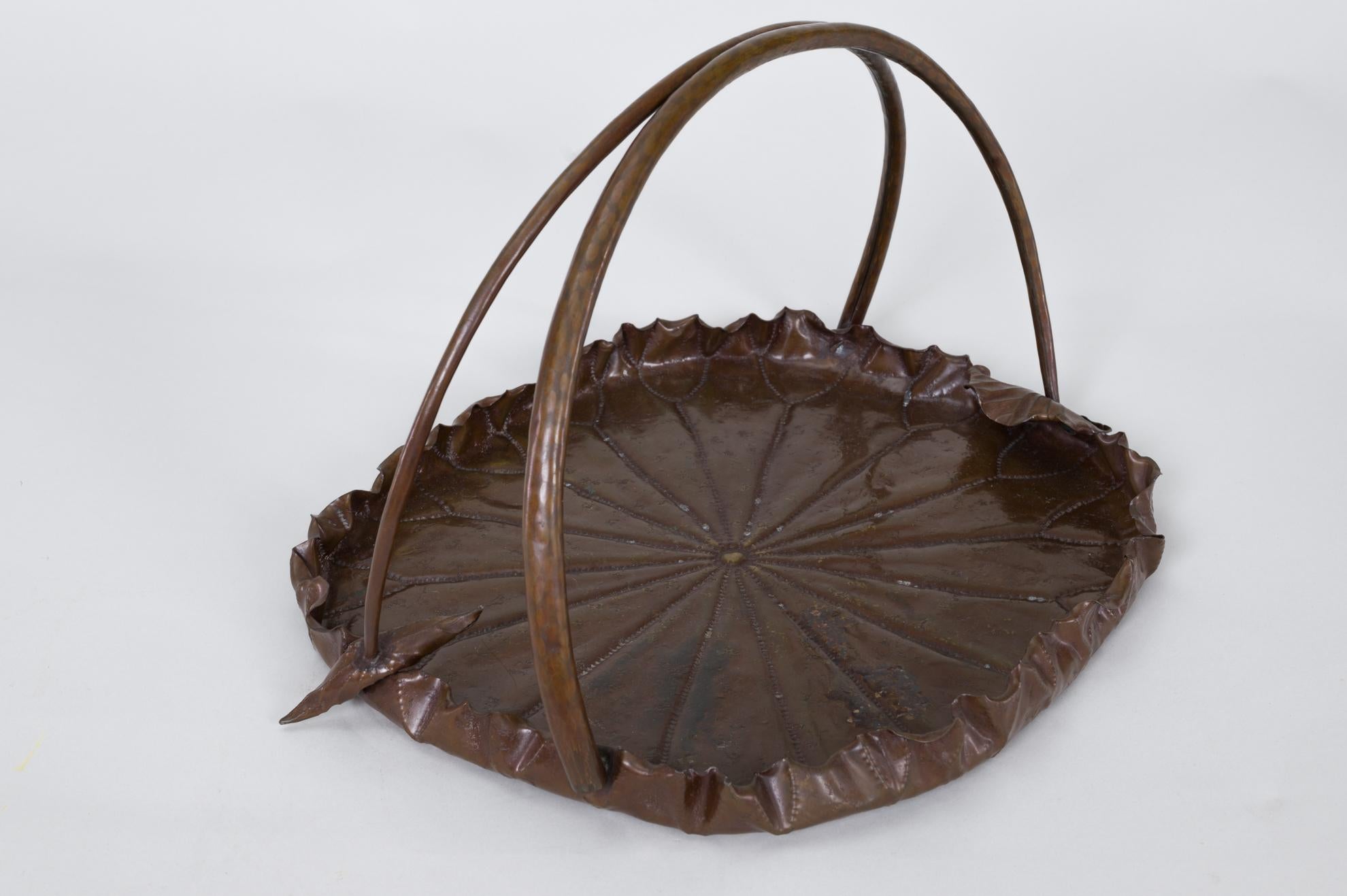 Meiji period copper lotus leaf tray. Meiji period (1868-1912) copper tray in the shape of a lotus leaf with hand tooled details, and a handle in the shape of two lotus stems with the recognizable hollow stem details that can be seen from underneath.