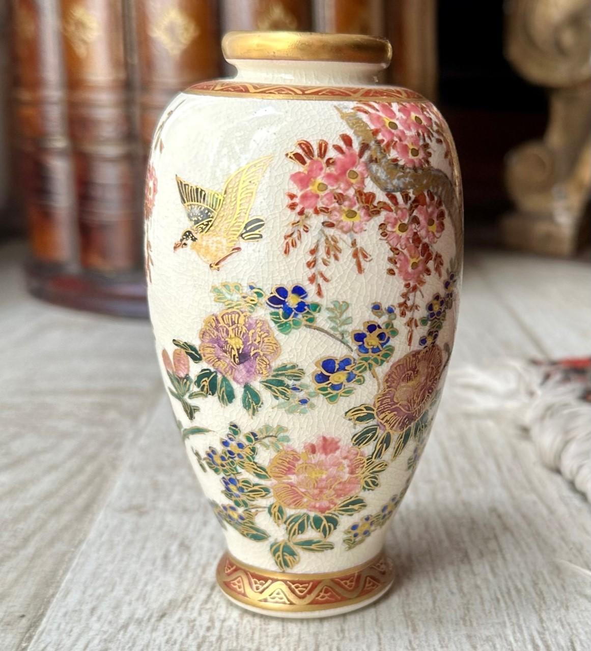 Meiji Period Diminutive Satsuma Baluster Vase.

This Japanese Satsuma vase from the late Meiji period is hand painted and gilt decorated with a Japanese landscape in exquisite detail. The scene in nature is lush with hanging boughs of flora and two