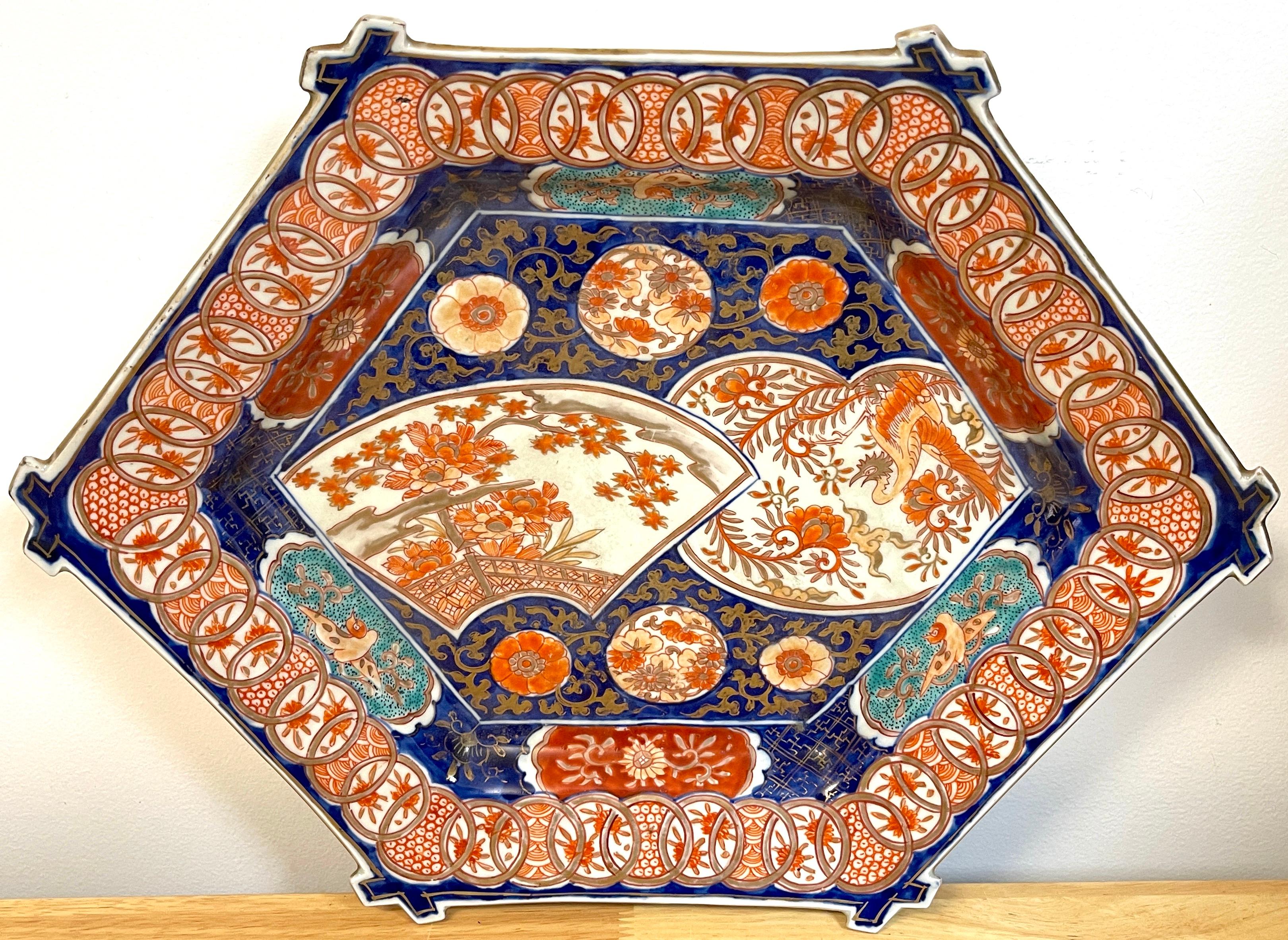 Meiji period imari fan dish, attributed to Fukagawa
With crossed bamboo borders with, the profusfeley decorated tiered center with numerous floating vignettes. Unmarked.
    