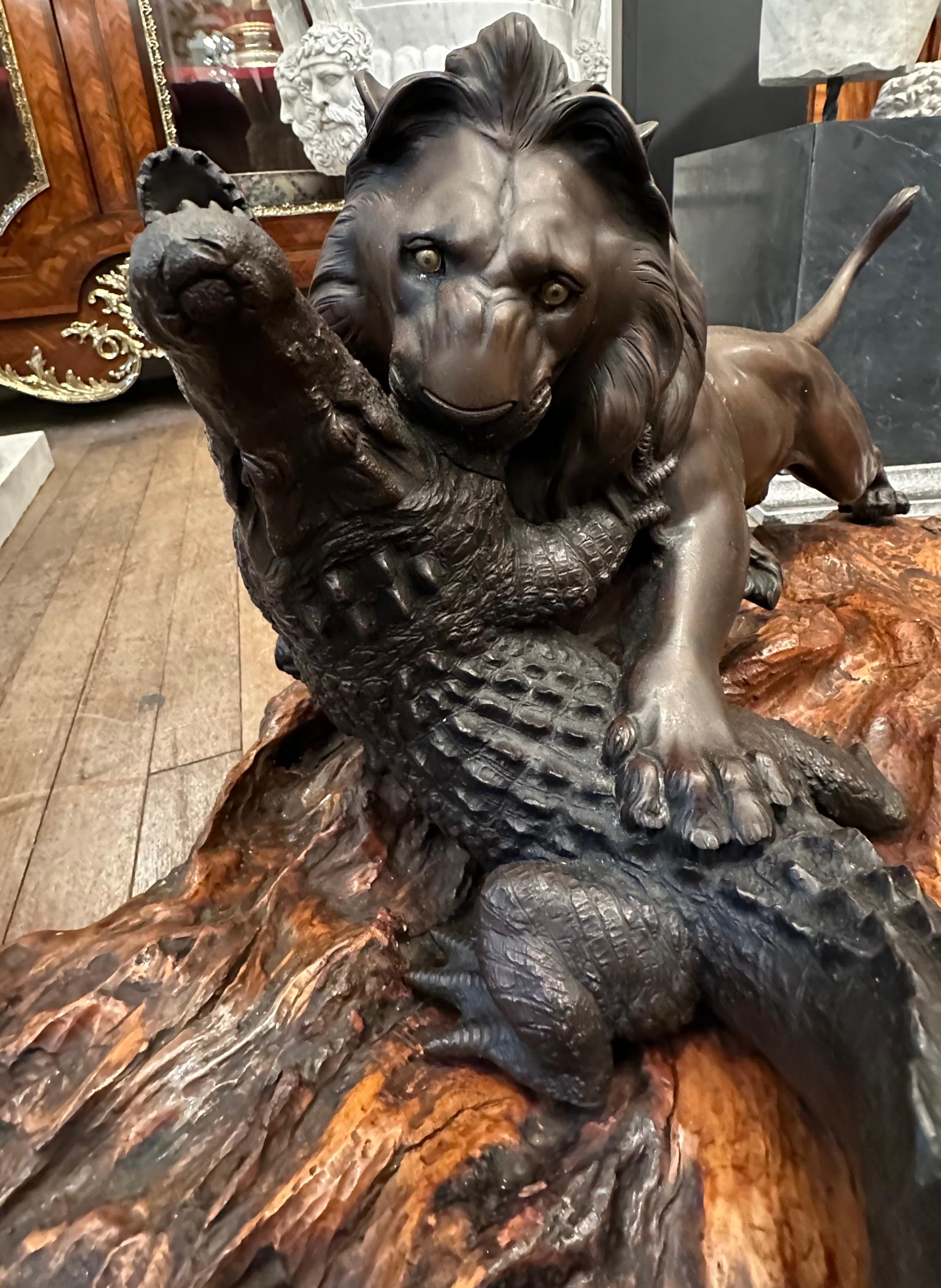 A delightful Meiji Period Japanese bronze lion and crocodile on a root wood base. A skilfully hand crafted piece that encapsulates the splendour of each animal from the lush lions mane and muscular body to the scales and ridges of the toughened skin