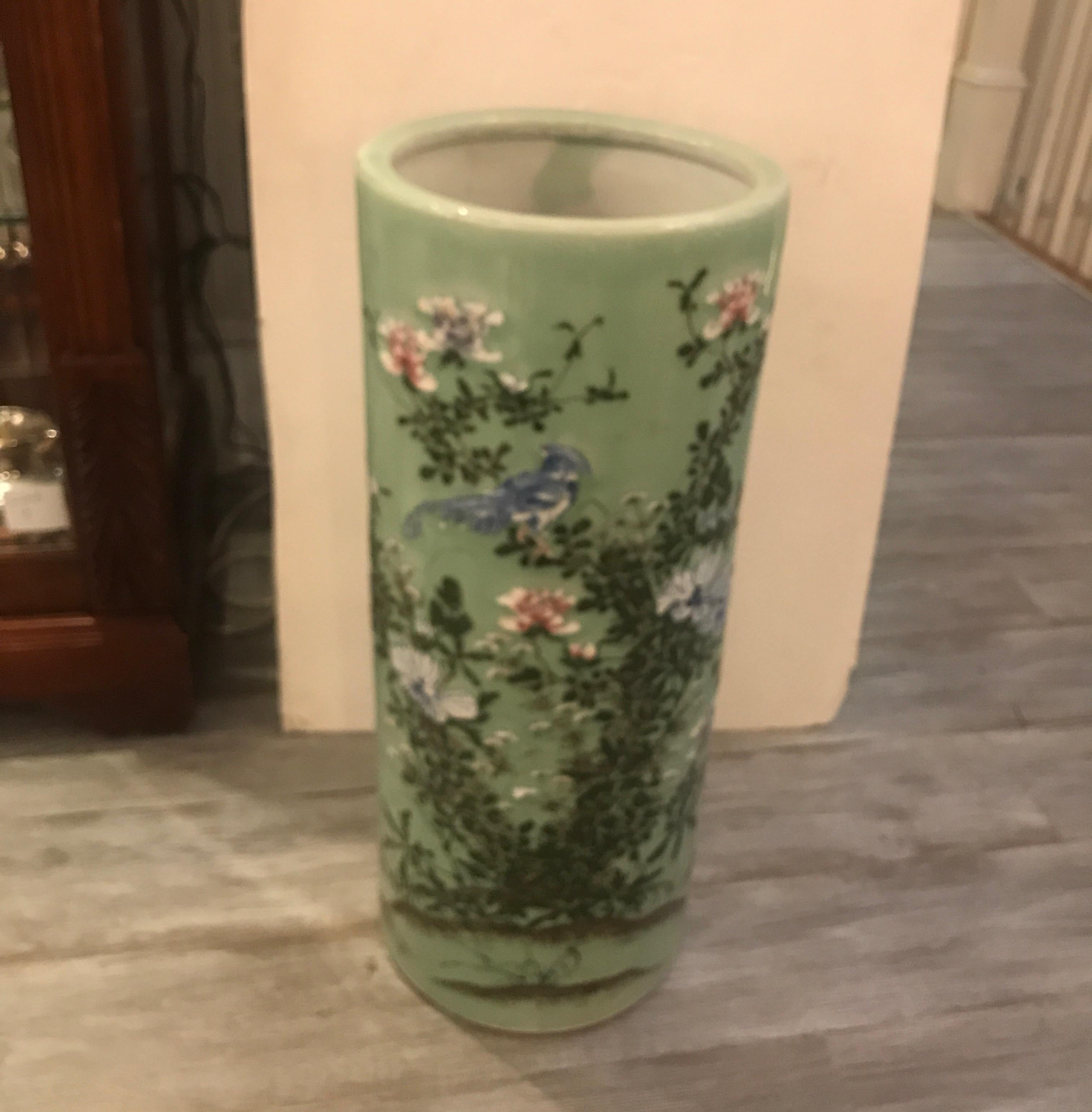 A Japanese porcelain hand painted decoration umbrella floor vase with celedon background. The hand painted porcelain Stand with floral decoration with birds and greenery, late 19th century.