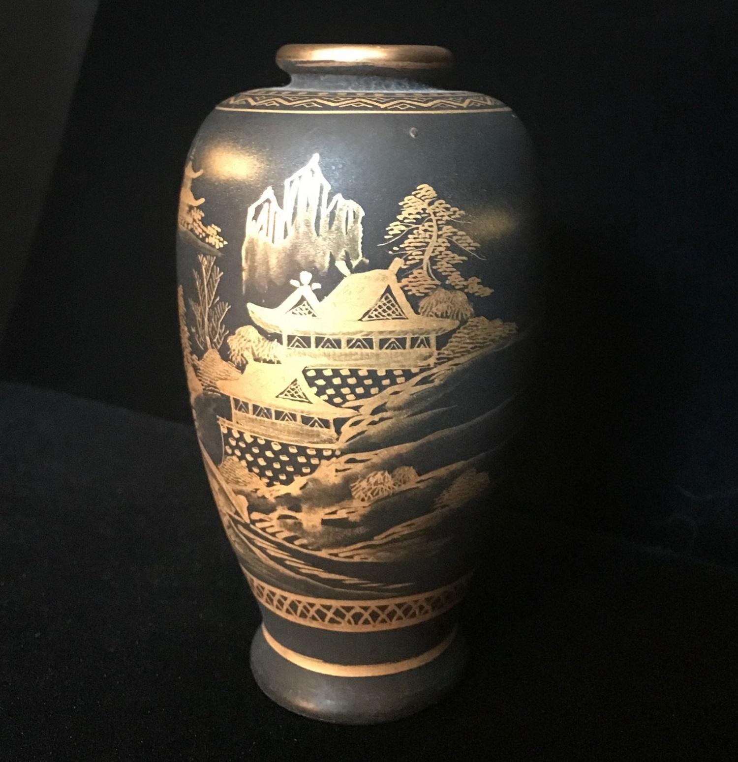This is an extremely rare miniature Japanese Satsuma miniature vase from the Meiji Period (1868-1911). It is superbly decorated with a finely detailed Japanese landscape in gold on black background. The vase is signed on the base.

Satsuma-ware