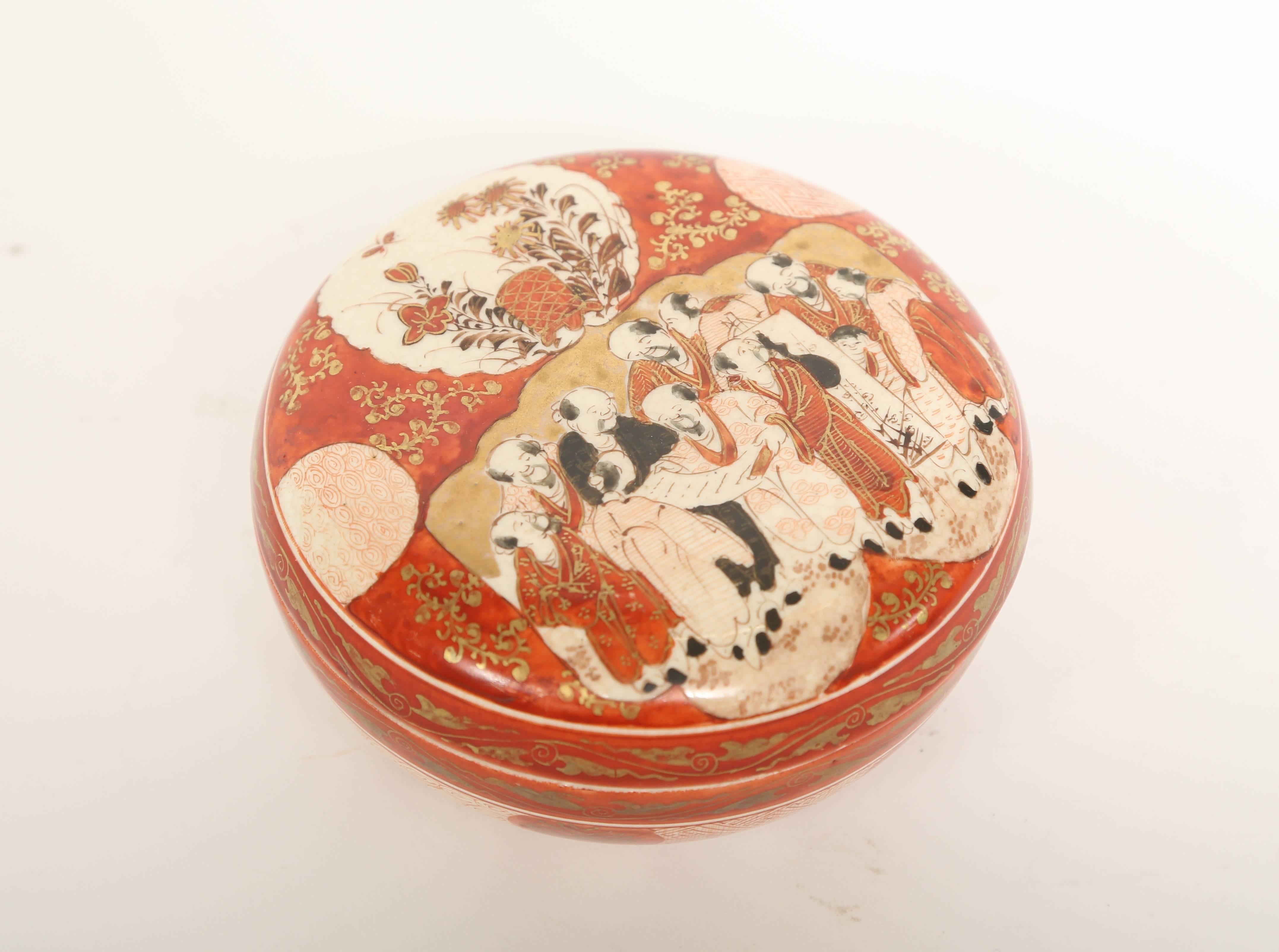 Meiji period Kutani (nine valleys) hand decorated round covered box. Hand decorated in iron red with details picked out in gold and black. The interior lid and box are decorated with dogwood blossoms. The characters on the base mean