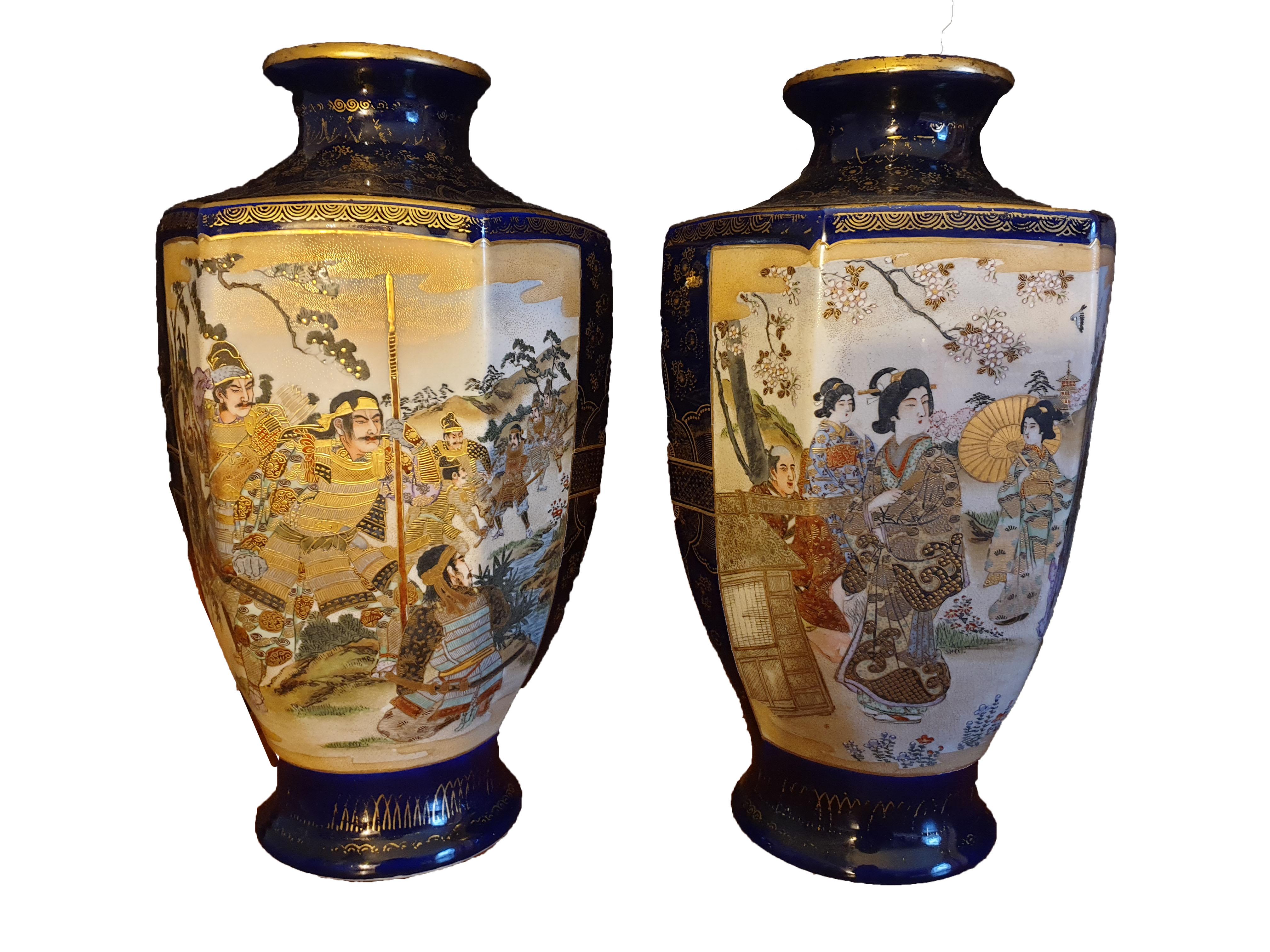A massive pair of Japanese Meji Period vases thats from 1880, each panelled in an hexagonal shape depicites a different scene. Fine gilding and hand enameling on 24-karat gold imitating lotus flowers, with Imperial scenes and spirit blossoms on a