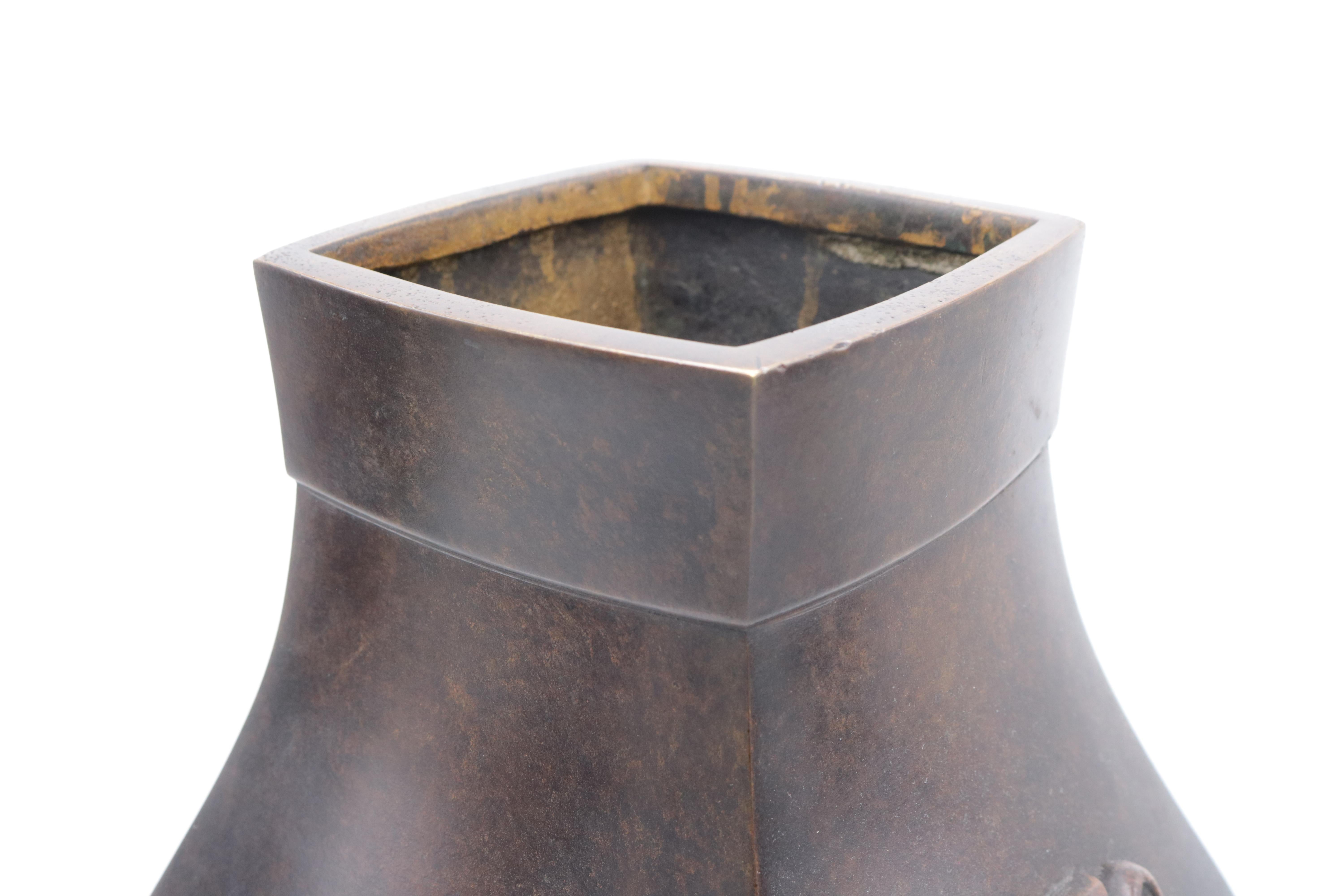 Large Meiji period patinated Japanese bronze vase with decorative handles.