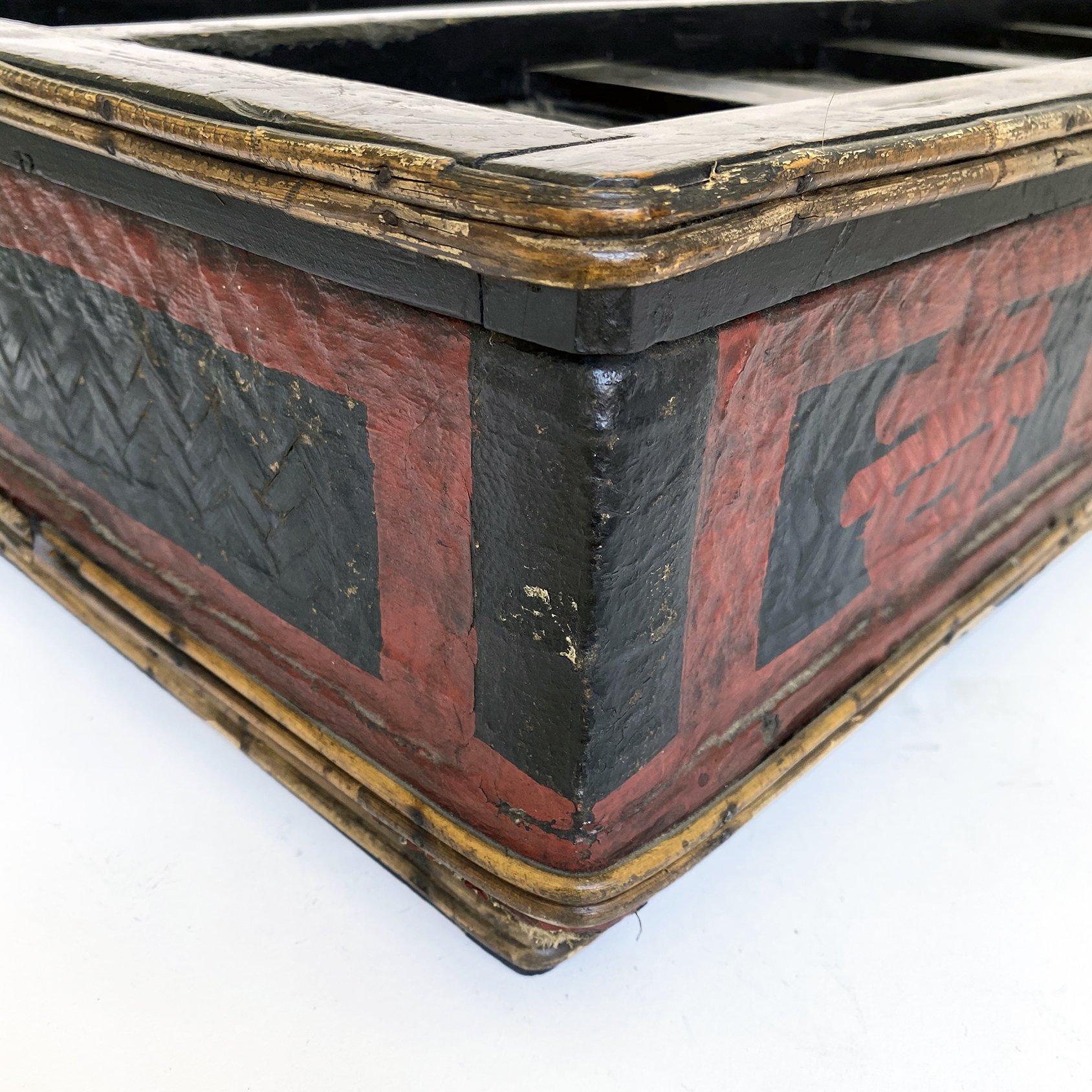 Japanese Kimono storage box, constructed of wood and bamboo, painted black with family crest painted in red on the sides. The top has wood slats, which convey strength and beauty. Both top and bottom is lined inside with paper to protect the
