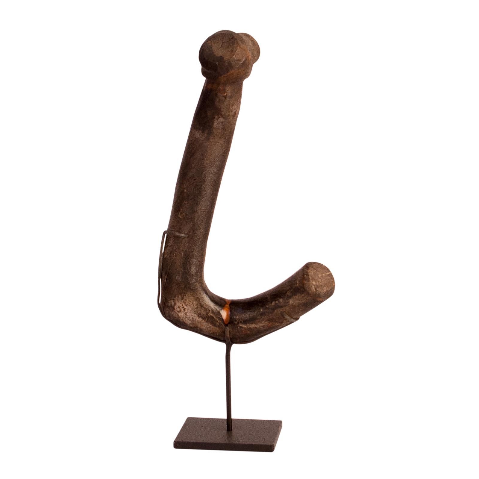 A curious and amusing Japanese wood kettle hook, circa 1880 on later custom stand. These decorative organic looking hooks where meant to hold a pot over a fire to keep its contents hot. We loved the wear and eccentric shape of the hook. We mounted