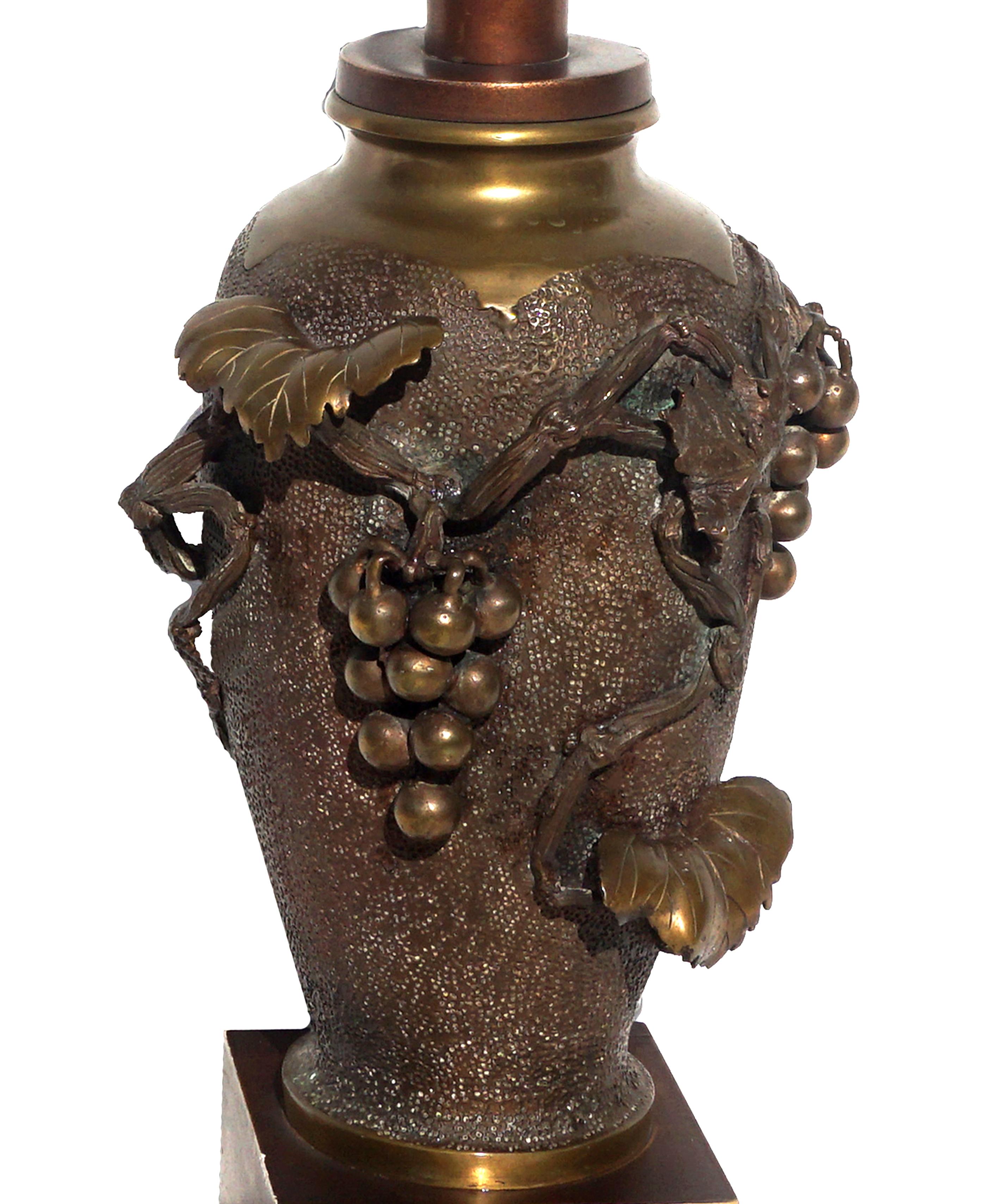 Gorgeous heavy Japanese bronze of Meiji period (1868-1912) vase converted into lamp unusually decorated with the most lifelike bunch of grapes trailing from a vine down the front center with the vine itself spread across the front and side of the