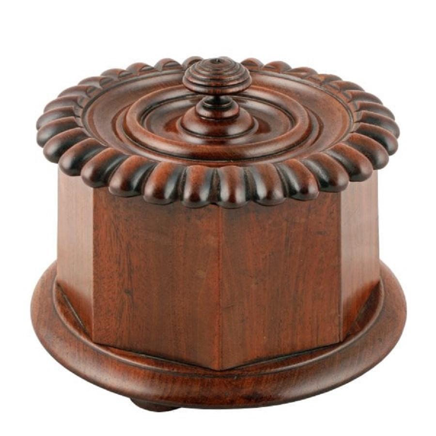 An early 19th century Georgian Scottish mahogany tobacco caddy probably by Mein of Kelso.

The caddy is circular with an octagonal tapering body and a turned and carved lid.

The turning and carving are in the style of Mein of Kelso in the