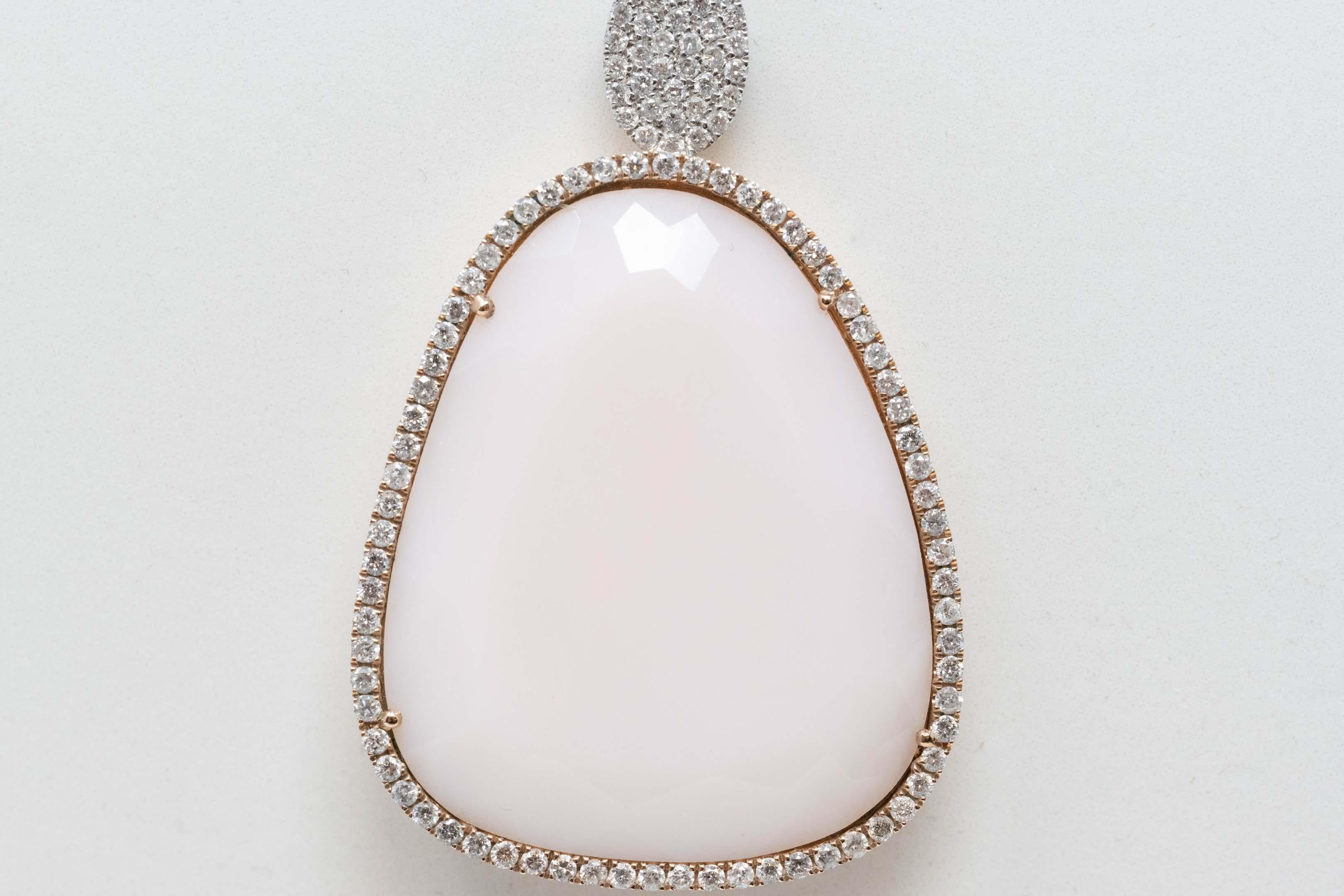 14k gold, pink opal and diamond pendant necklace. The chain measures 16 inches long, the pendant 40mm x 26mm. Set with 107 diamonds and a light pink opal stone. Mark and maker mark are on the tag. In good condition.