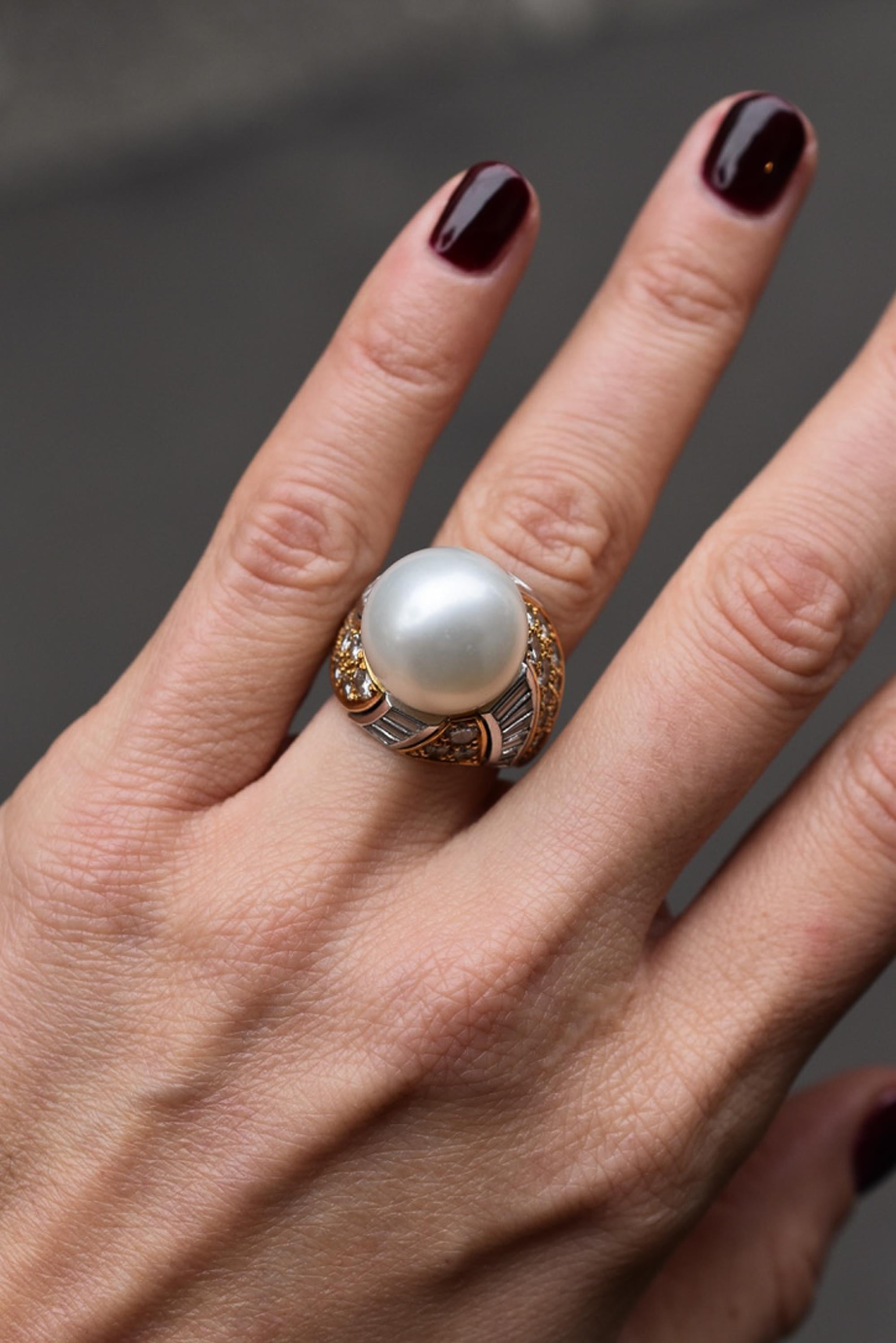 A Meiser Cultured Pearl and Diamond Ring mounted in 18k yellow gold, showcasing a  15.2mm cultured pearl within a bicoloured brilliant and tapered baguette-cut diamond surround, for a total approx. weight of 2.60cts.
Ring size approx. L (leading